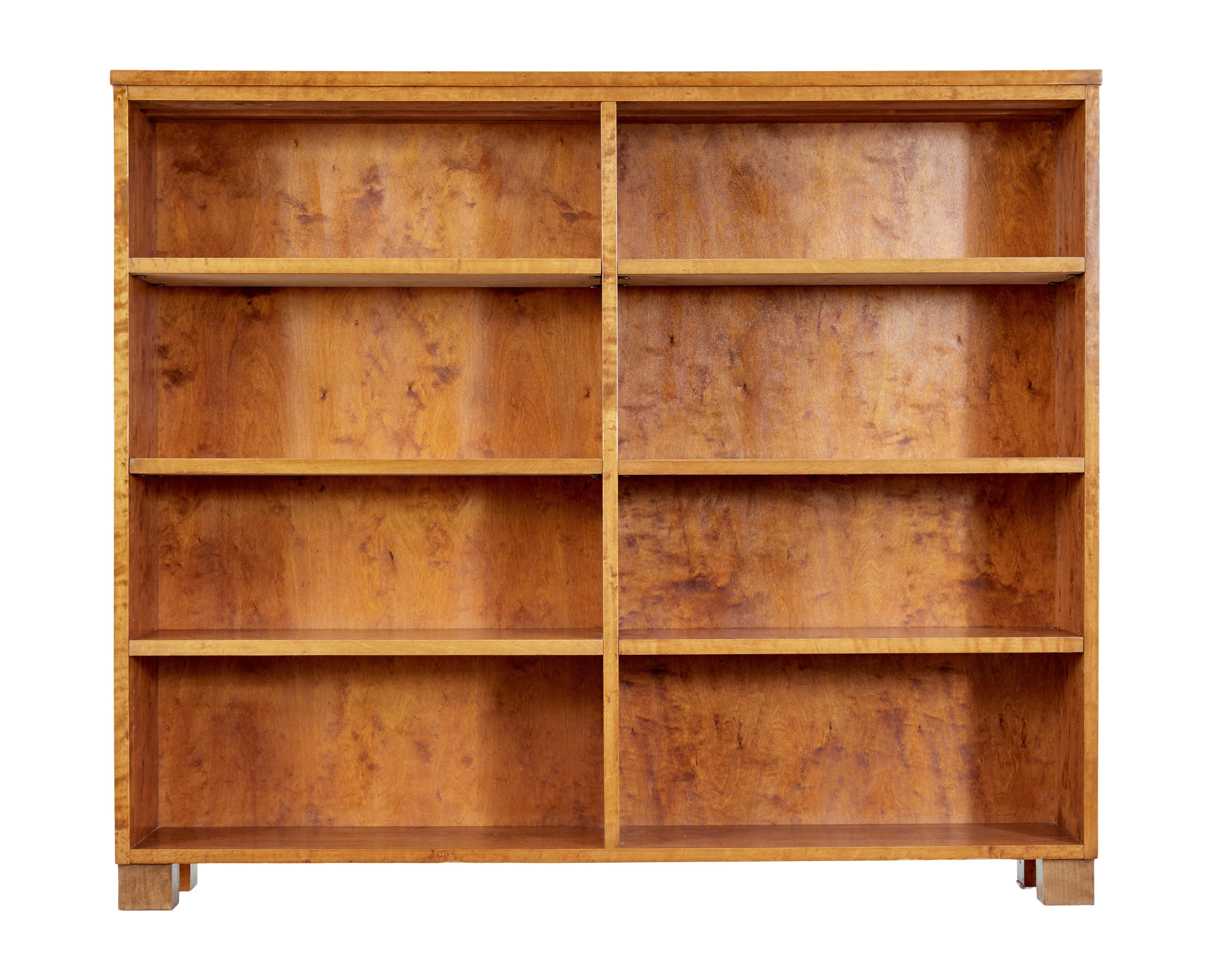 Mid 20th century birch tall open bookcase circa 1950.

Swedish tall open bookcase, made in a golden birch. Featuring 3 adjustable shelves either side of a central partition.

Standing on block feet. Recently re-finished in our workshop.