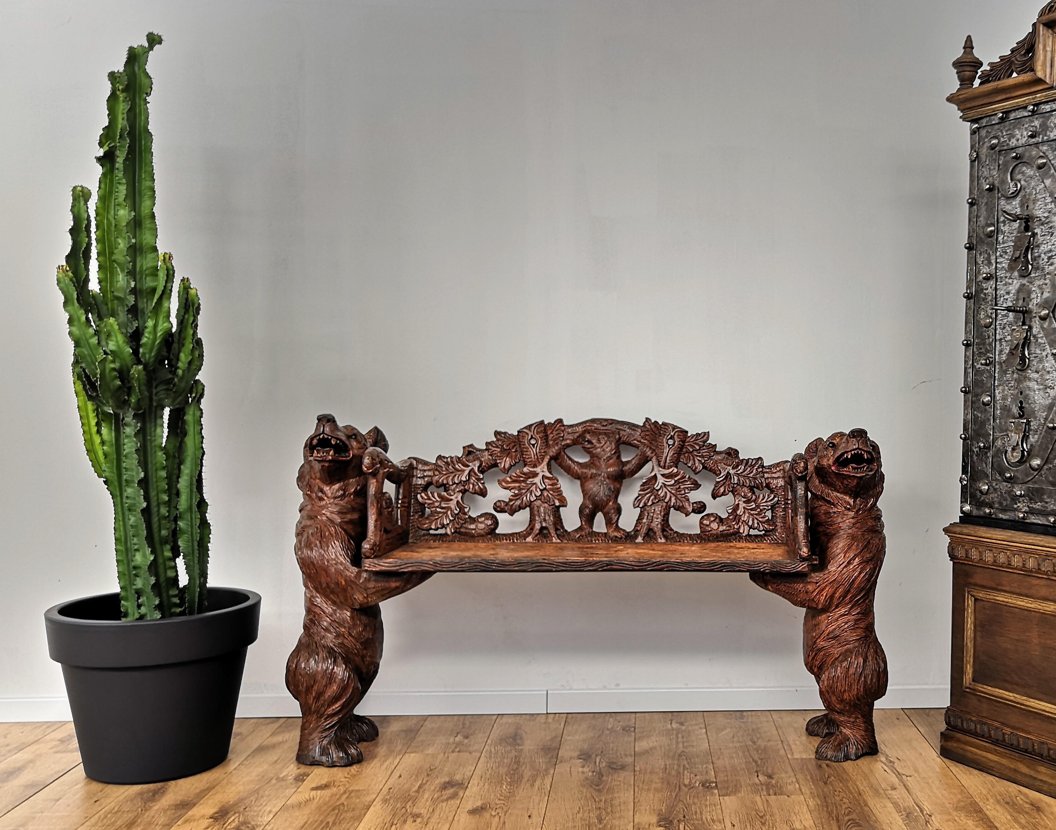 A superb mid-20th century Black Forest bear bench. The two side bears are extremely finely carved, both in the facial expression as well as in the detailed fur skin with glass eyes supporting a carved bench with carvings of various leaves and a bear