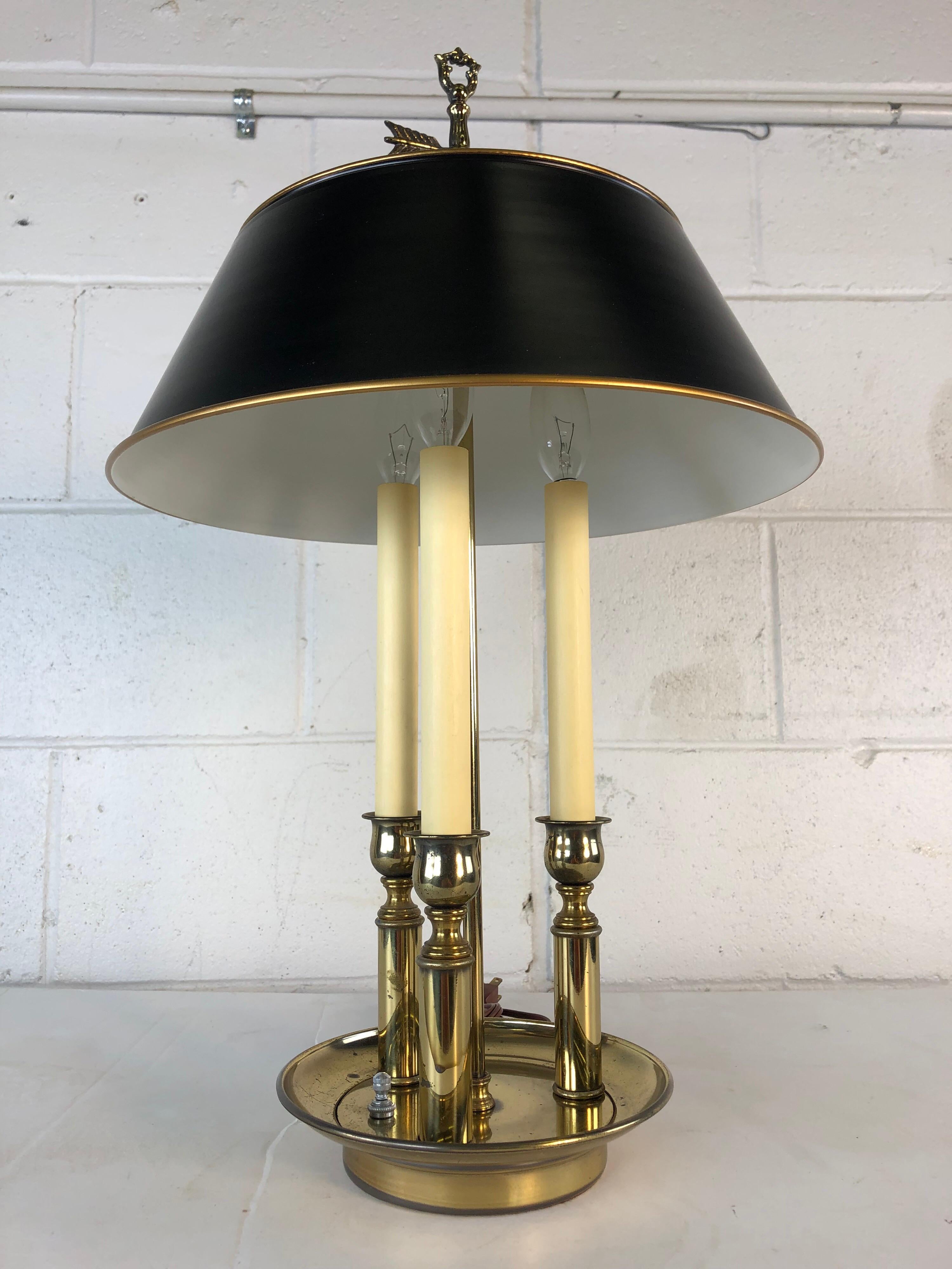 Mid-20th century black and gold metal bouillotte desk table lamp. Has three chandelier lights and they operate separately or all together. Wired for the US and in working condition. Shade alone measures 13” diameter x 5” height. Brass has some