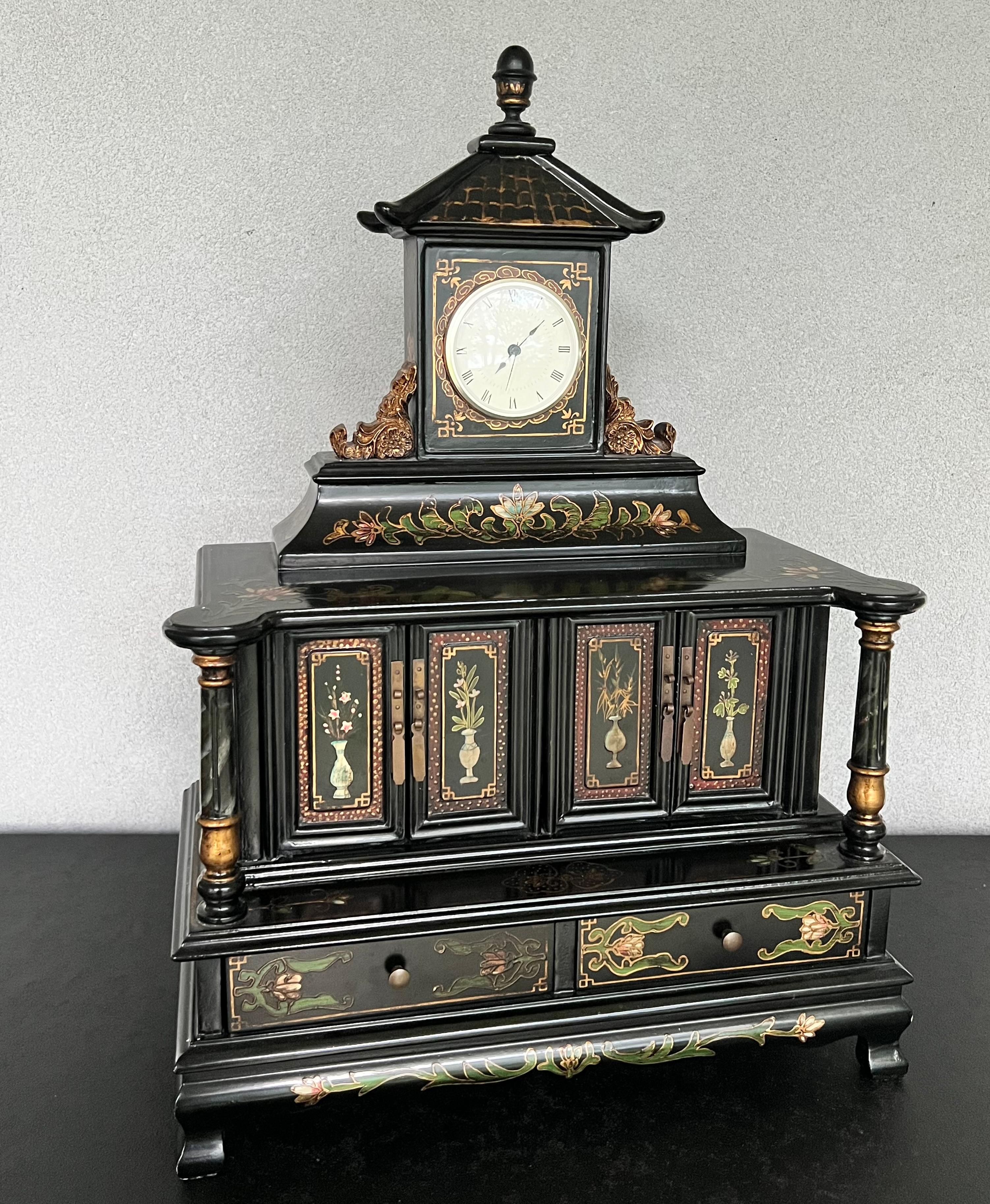 Stunning Jewelry box with a pagoda style beautifully decorated, has a working clock that can be removed with a push through a hole on the back to adjust time or change battery 
This piece is really amazing and would be a statement piece on your
