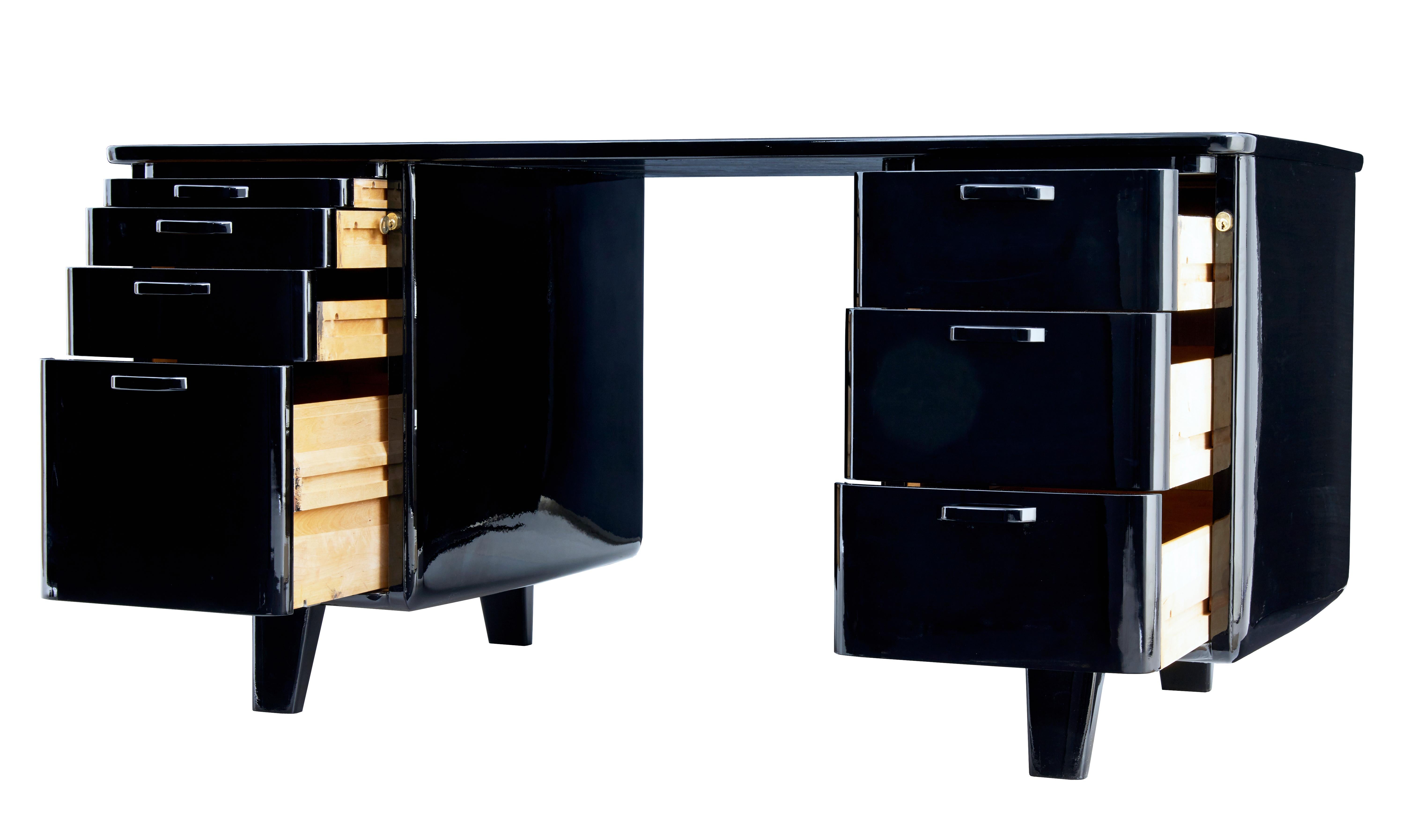 Mid 20th century black lacquered desk by atvidabergs circa 1950.

Stunning Swedish art deco inspired 1 piece desk made by atvidabergs. We have had this desk lacquered to a piano finish at great expense, which provides this unique looking