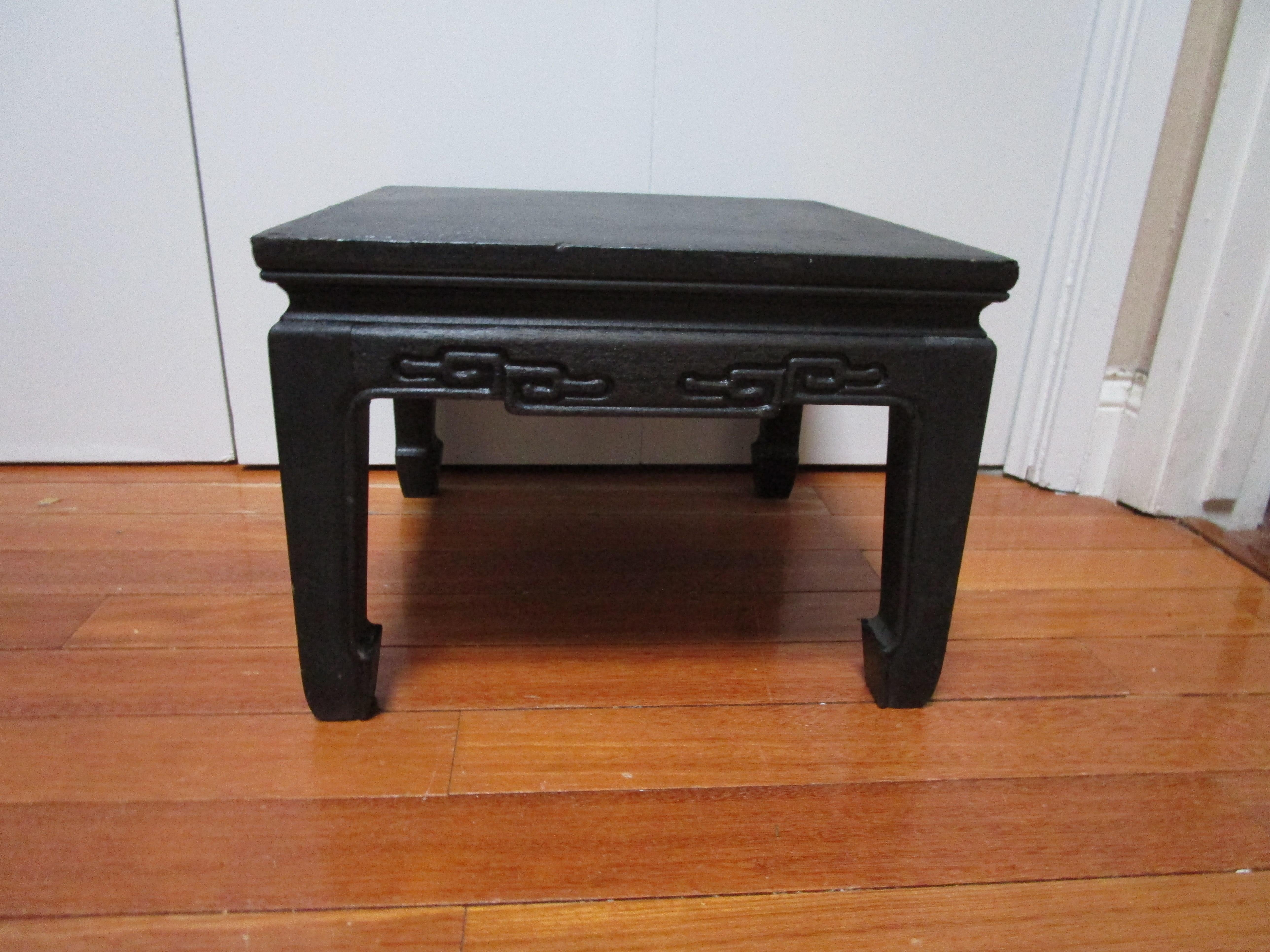 This Chinese foot rest is special. It is hand carved from heavy wood, possibly Ironwood with a cylindrical roller, and raised on four stout legs. 
It is from the Mid-20th Century. The ironwood provides the stool with a stunning texture. Our