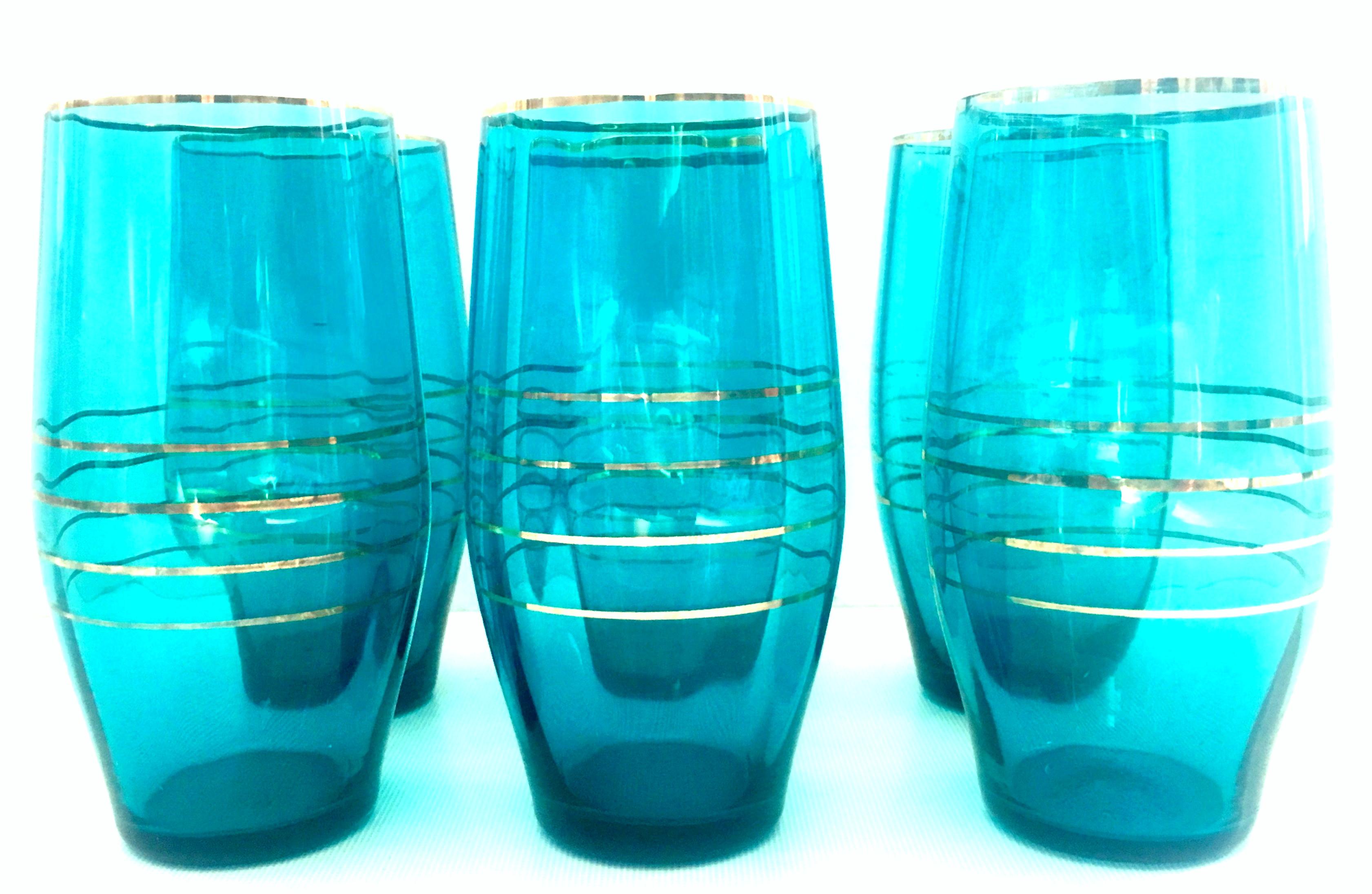 Mid-20th century modern blown glass & 22-karat gold drink glass set of six pieces. These turquoise and 22-karat trim optic blown glass tumblers are a set of six pieces.