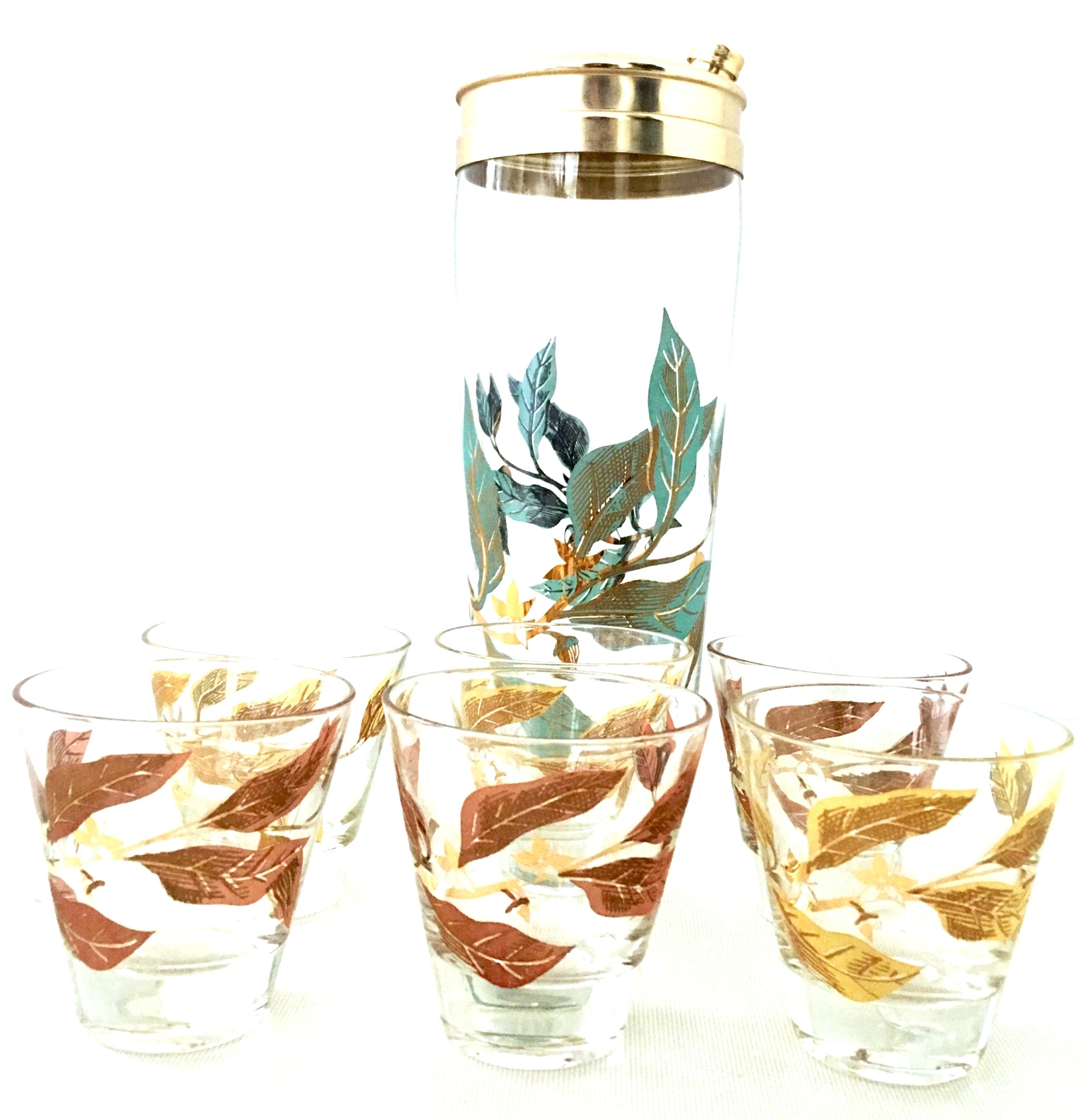 Mid-20th century blown glass and 22-karat gold printed drinks set of seven pieces. This blown glass, printed with 22-karat gold detail set features a leaf motif. Set includes, one cocktail Shaker and six shot glasses. The shot glasses come in two