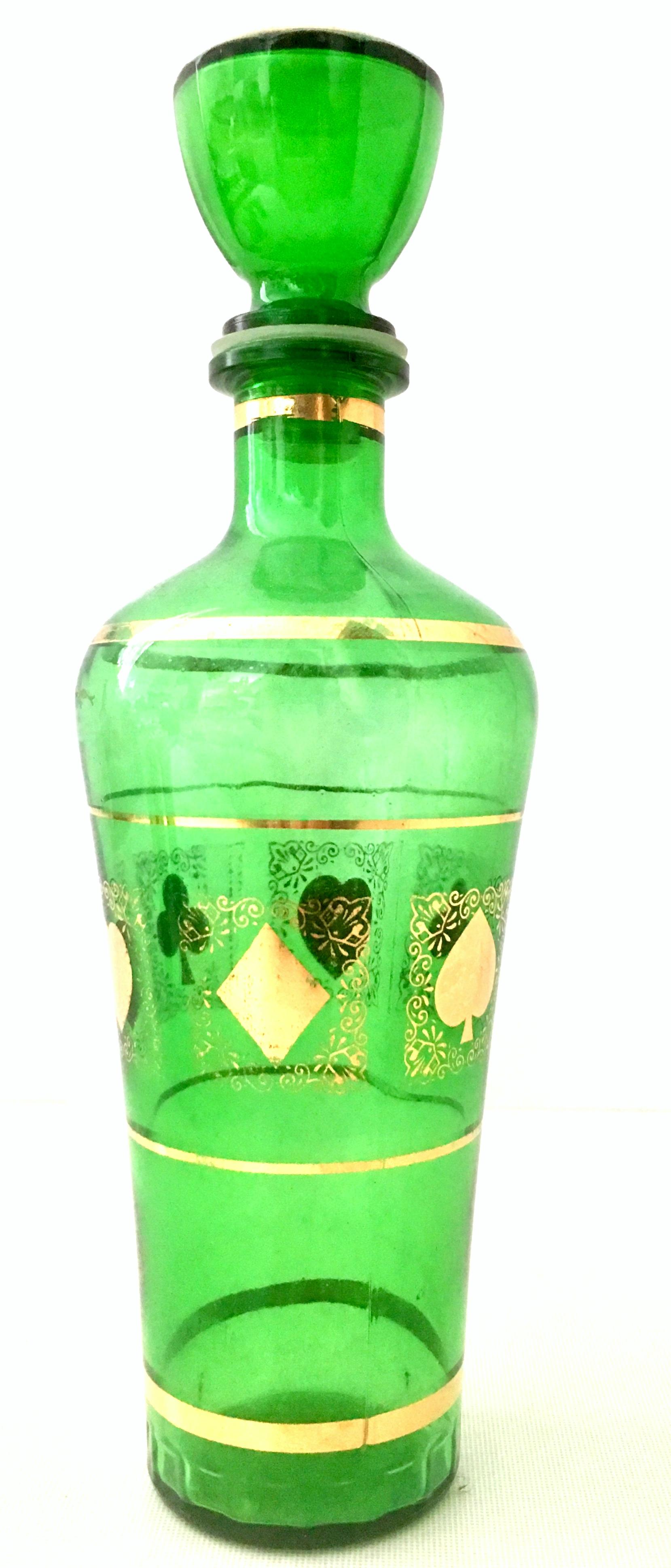 Mid-20th century blown glass & 22k gold drinks set of four pieces. This unique and coveted blown glass and 22K Gold embellished drinks set features a deck of playing card motif. Set Includes one decanter with stopper and three shot glasses. To
