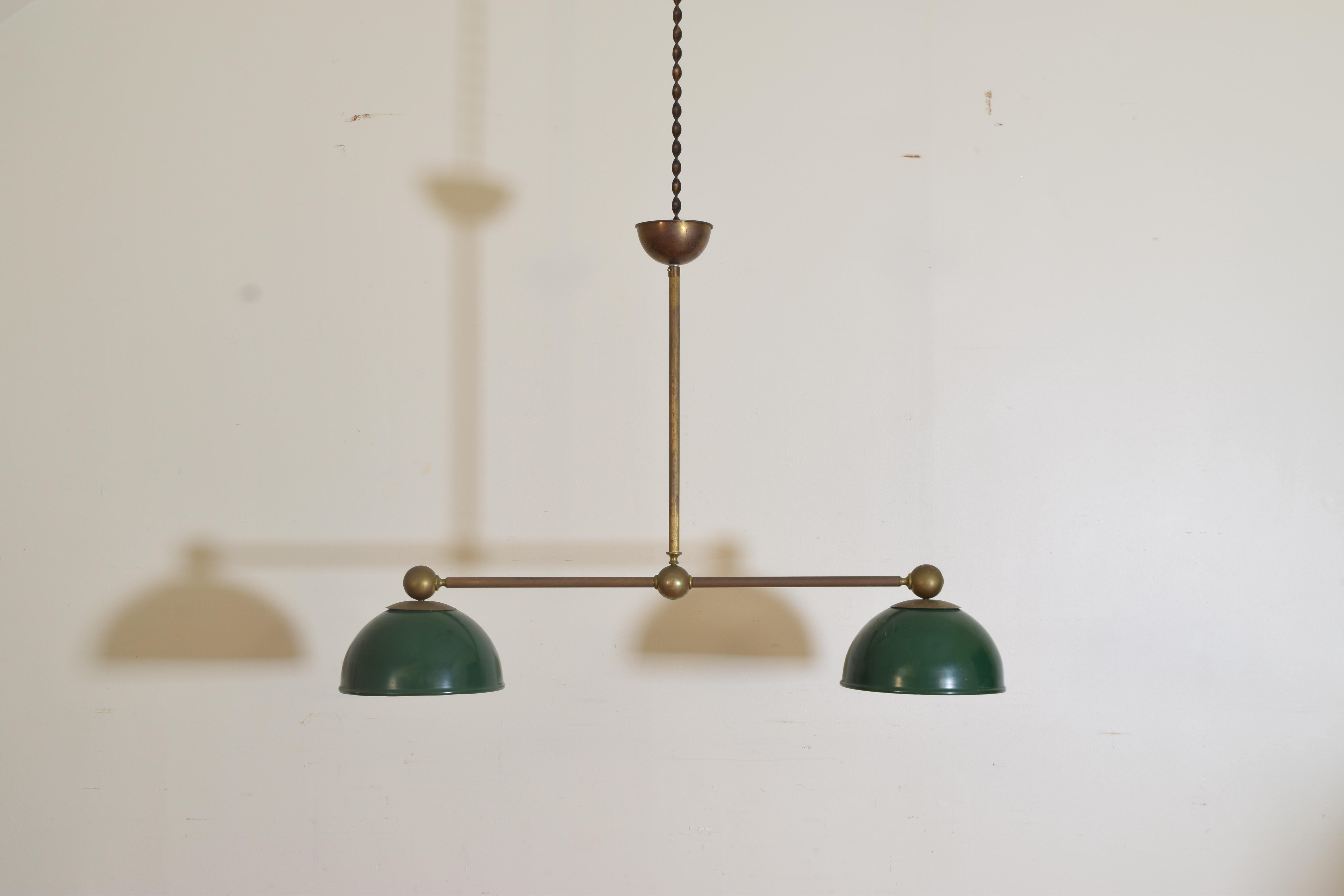 A handsome shade of green enameled on this billiard's brass and tole two pendants. Having a brass stretcher between the lights with ball finials and decoration. Price does not include wiring.