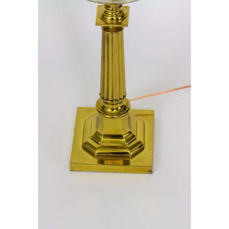 Stately lamp with a cut glass font and squared column stem and base. In excellent condition. Original lacquered brass finish has been cleaned and the lamp has been newly rewired. Single bulb, 100 watt Max.

Dimensions: 7 × 7 × 29 in.