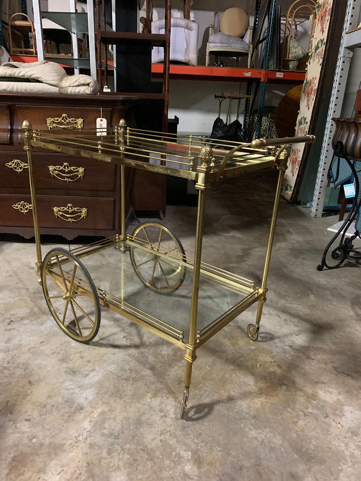 Mid-20th century brass bar cart.
two glass shelves
