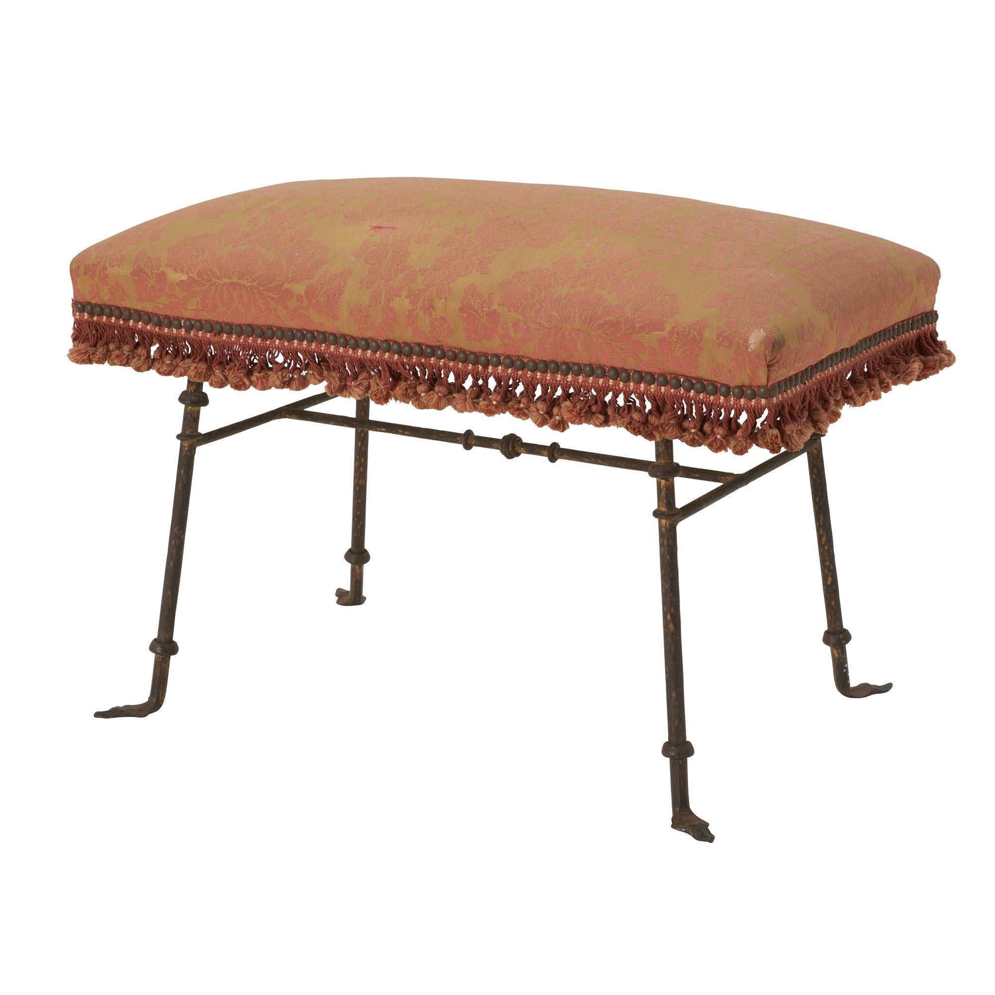 This Mid 20th Century Bench features a brass frame with a red/orange damask cushion and tassels.

Since Schumacher was founded in 1889, our family-owned company has been synonymous with style, taste, and innovation. A passion for luxury and an