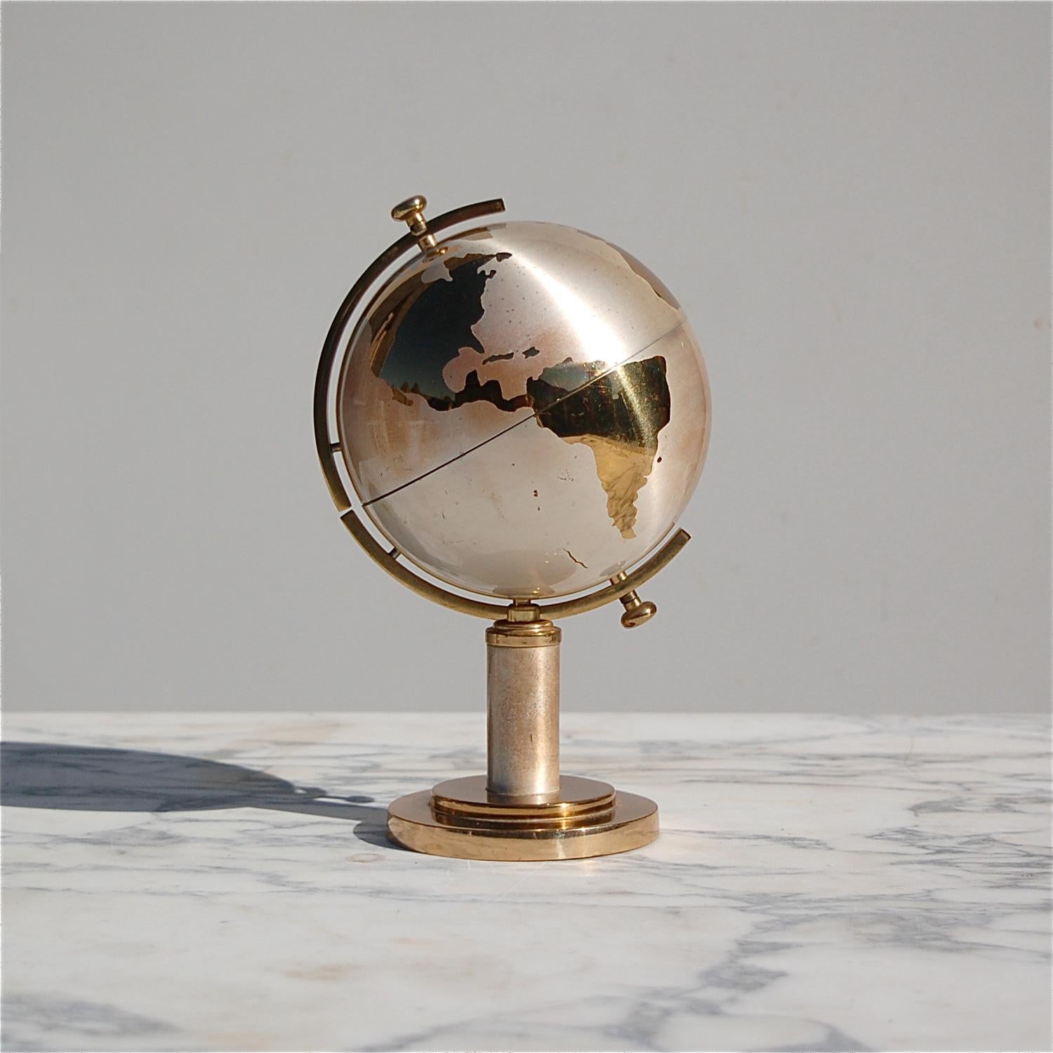 At first sight, you'd never imagine this shiny globe would morph into a cigarette dispenser. By a simple pull, the top hemisphere slides open revealing the inner compartment with room for 25 cigarettes. This lovely decorative item is very evocative