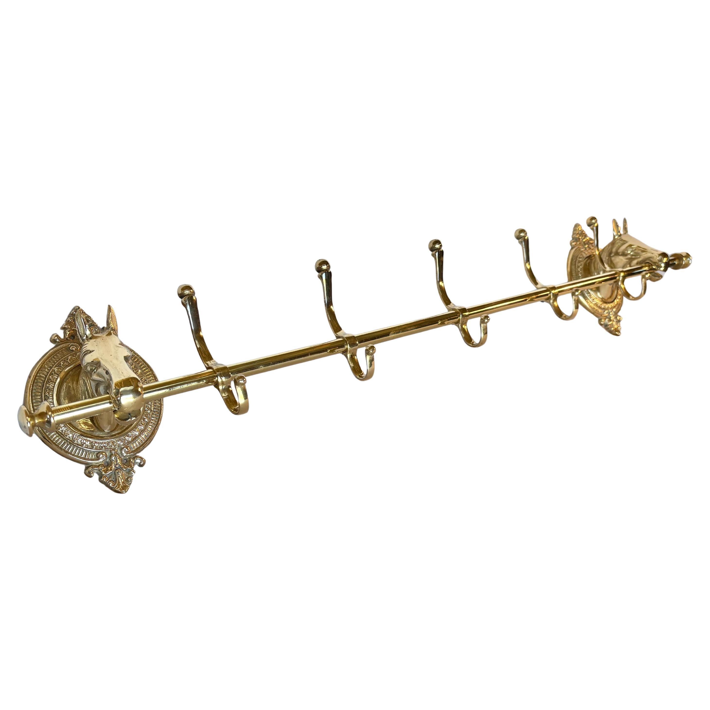 Este gran perchero o perchero con cabeza de caballo de mediados del siglo XX se fabricó en latón a mediados de la década de 1900. La pieza presenta dos cabezas de caballo montadas sobre placas ovaladas de latón intrincadamente detalladas que están