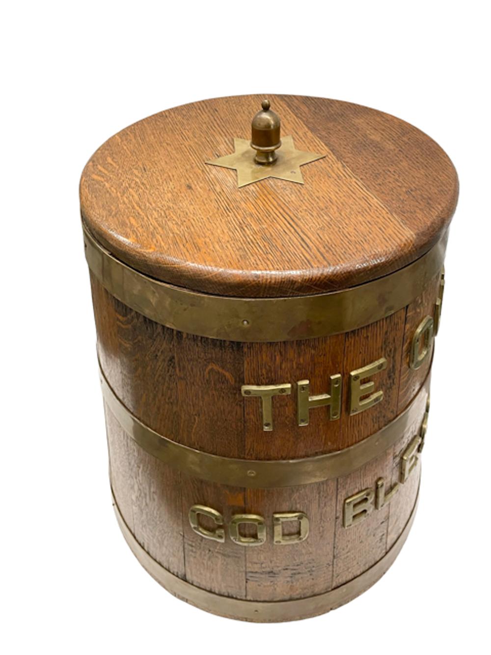 British Naval oak grog barrel or tub, used aboard British ships. The tapered barrel of staved oak with three brass bands. The ‘Royal Toast’, in large brass letters between the bands 