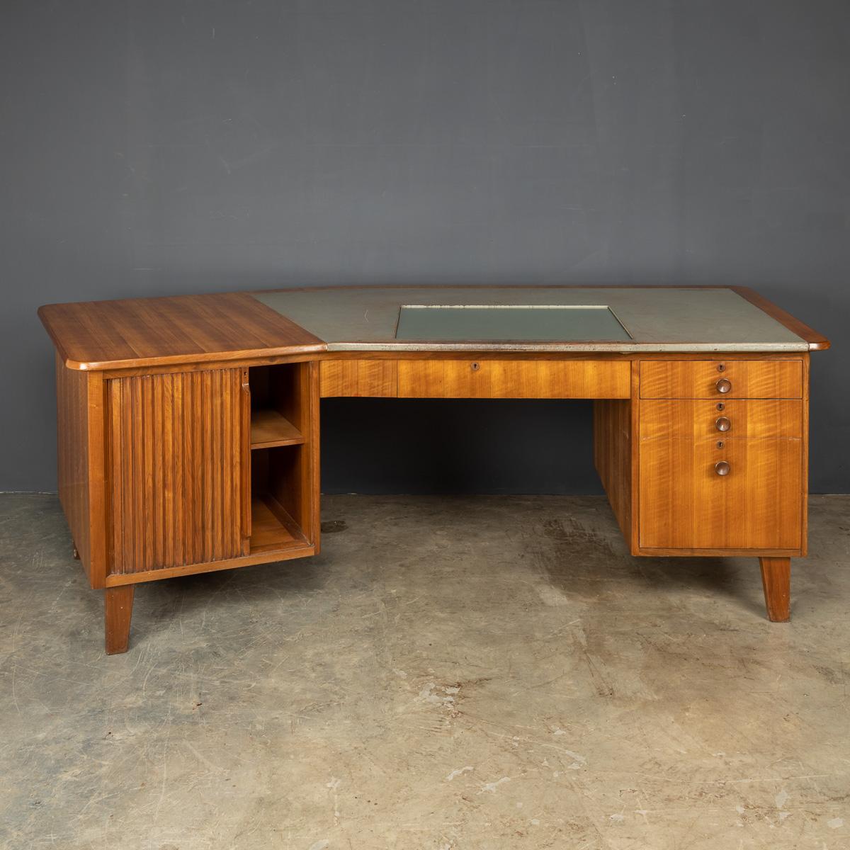 Iconic mid 20th Century Gordon Russell desk, walnut and mahogany studio desk, the unusually shaped top above drawers. Designed by Gordon Russell and sold through Heal's of London, c.1950.

CONDITION
In Great Condition - wear as