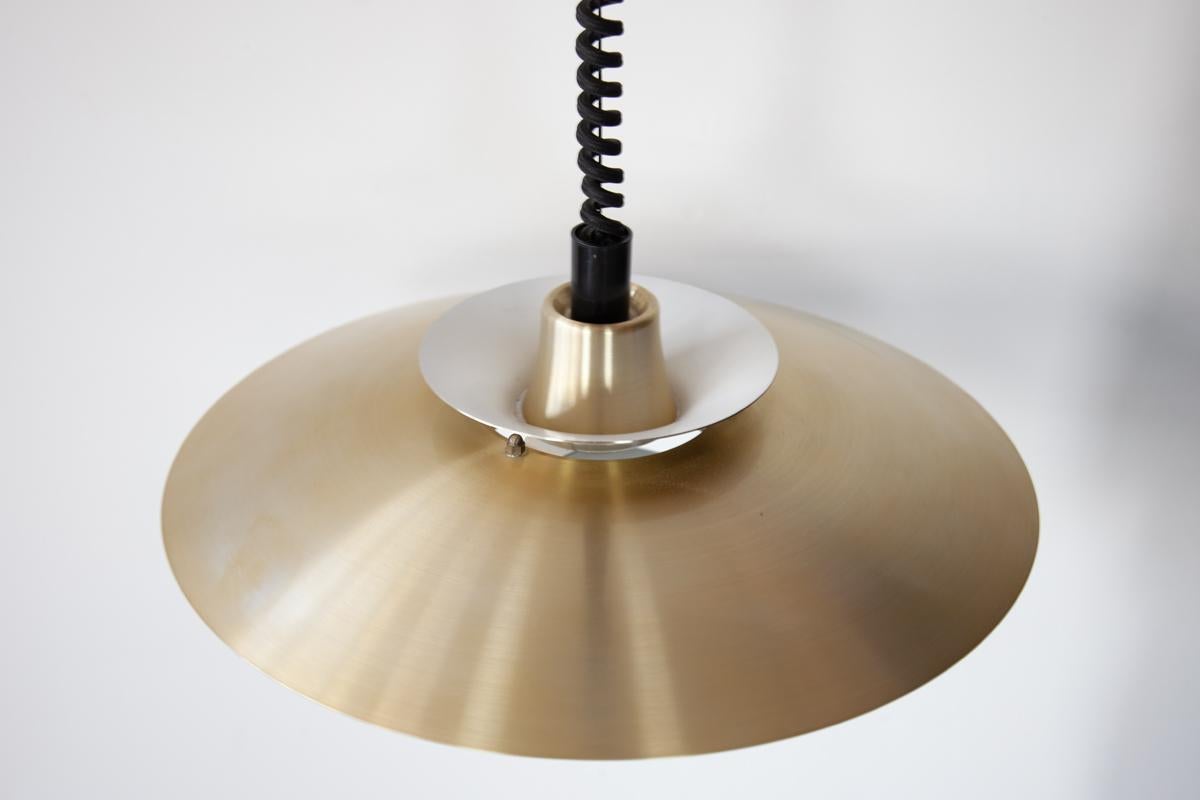 A brushed gold aluminium pendant light with the classic multi shade system designed by Jeka of Denmark in the 1960's. This type of pendant is designed to spread the light perfectly in the room. This pendant has the 