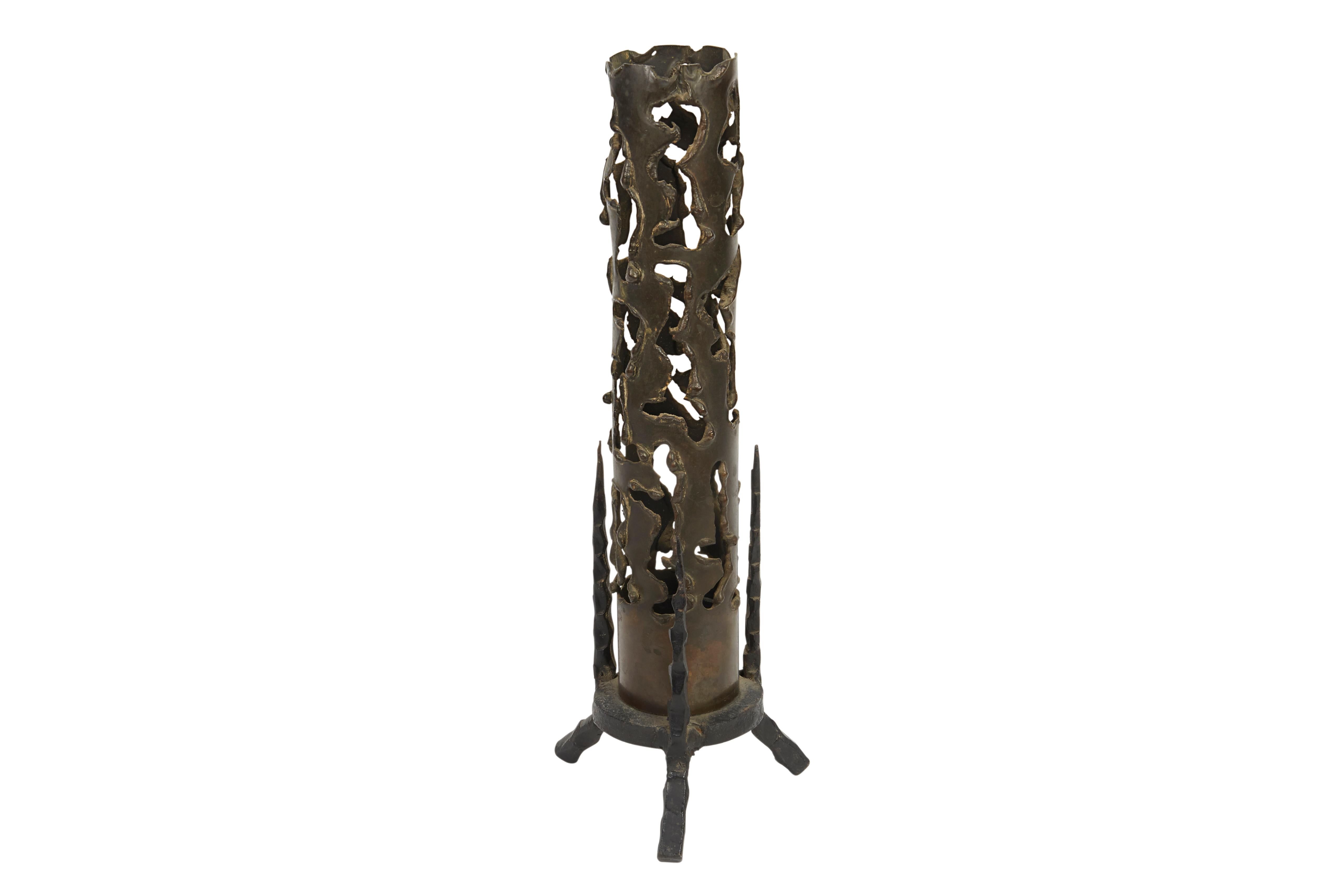 Pierced brass cylinder and iron base form this beautiful Memorial candle, crafted in brutalist style by David Palombo. Reminiscent of the Pillar of Fire, which provides a scared element to this ritual object, the length of the holder allows the