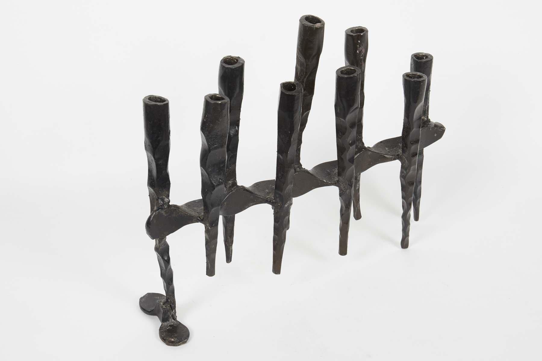 Hand forged, iron Hanukkah lamp Menorah in the style known as “Brutalism”, David Palombo, Jerusalem, Israel, circa 1950.

David Palombo (1920-1966), was a sculptor and painter. He was born in Turkey and immigrated to Israel with his parents in 1923.