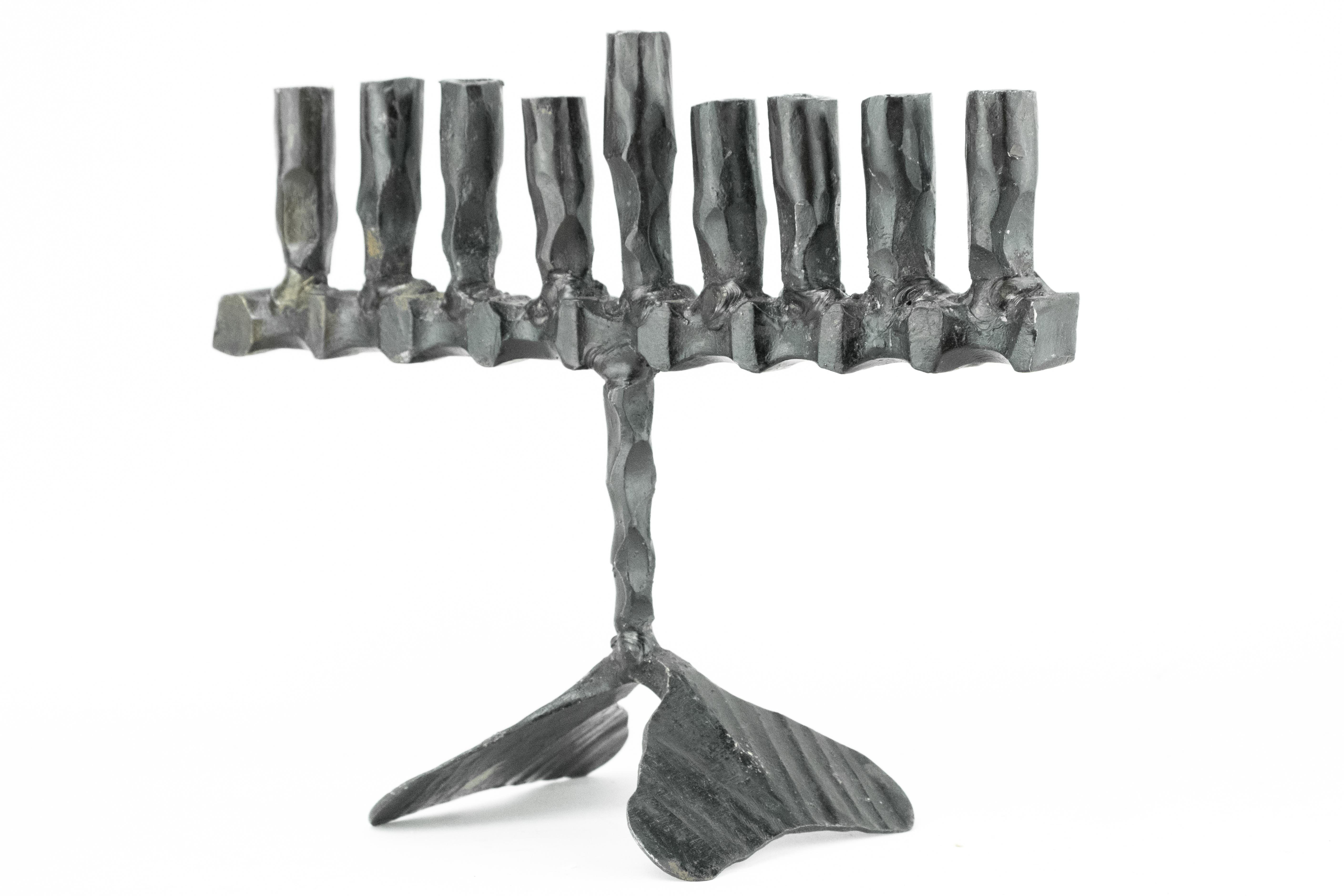Hand forged, iron Hanukkah lamp Menorah in the style known as “Brutalism”, David Palombo, Jerusalem, Israel, circa 1955.

David Palombo (1920-1966), was a sculptor and painter. He was born in Turkey and immigrated to Israel with his parents in 1923.