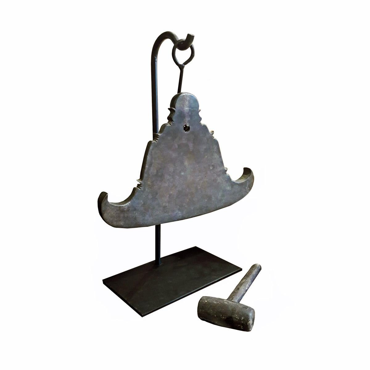 A Burmese gong from a Buddhist temple, circa 1950. Made of solid cast bronze in the shape of a temple or pagoda. Mounted on a black metal Stand. Includes its original wood mallet, which produces a deep, harmonious sound. 

9
