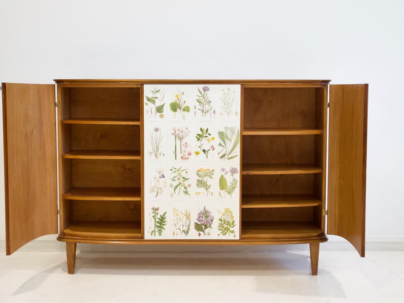 Wooden cabinet decorated with illustrations from the book 