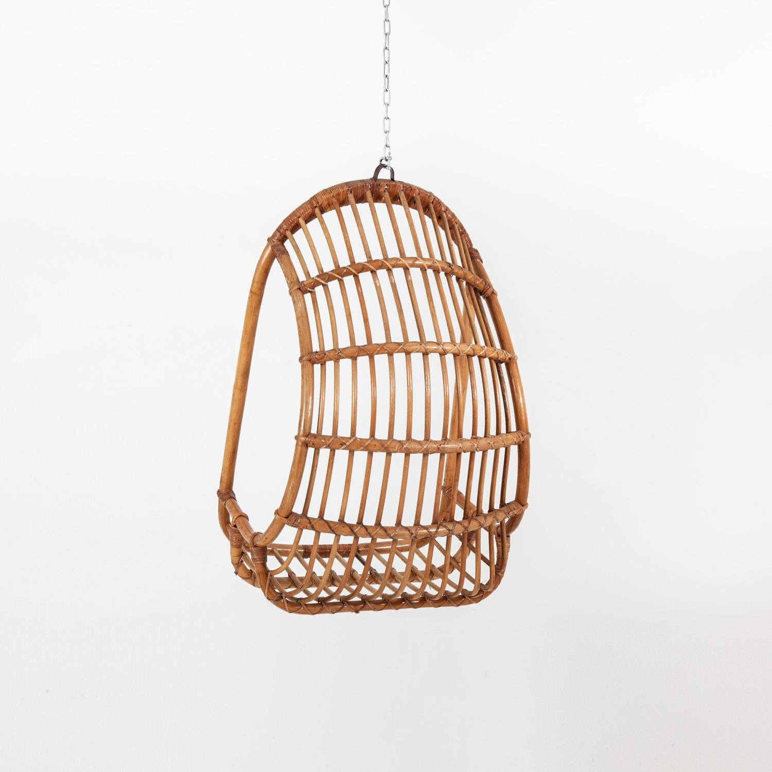 Stylish mid-20th century cane hanging chair.

Measures: Height 108cm x width 70cm x depth 70cm.