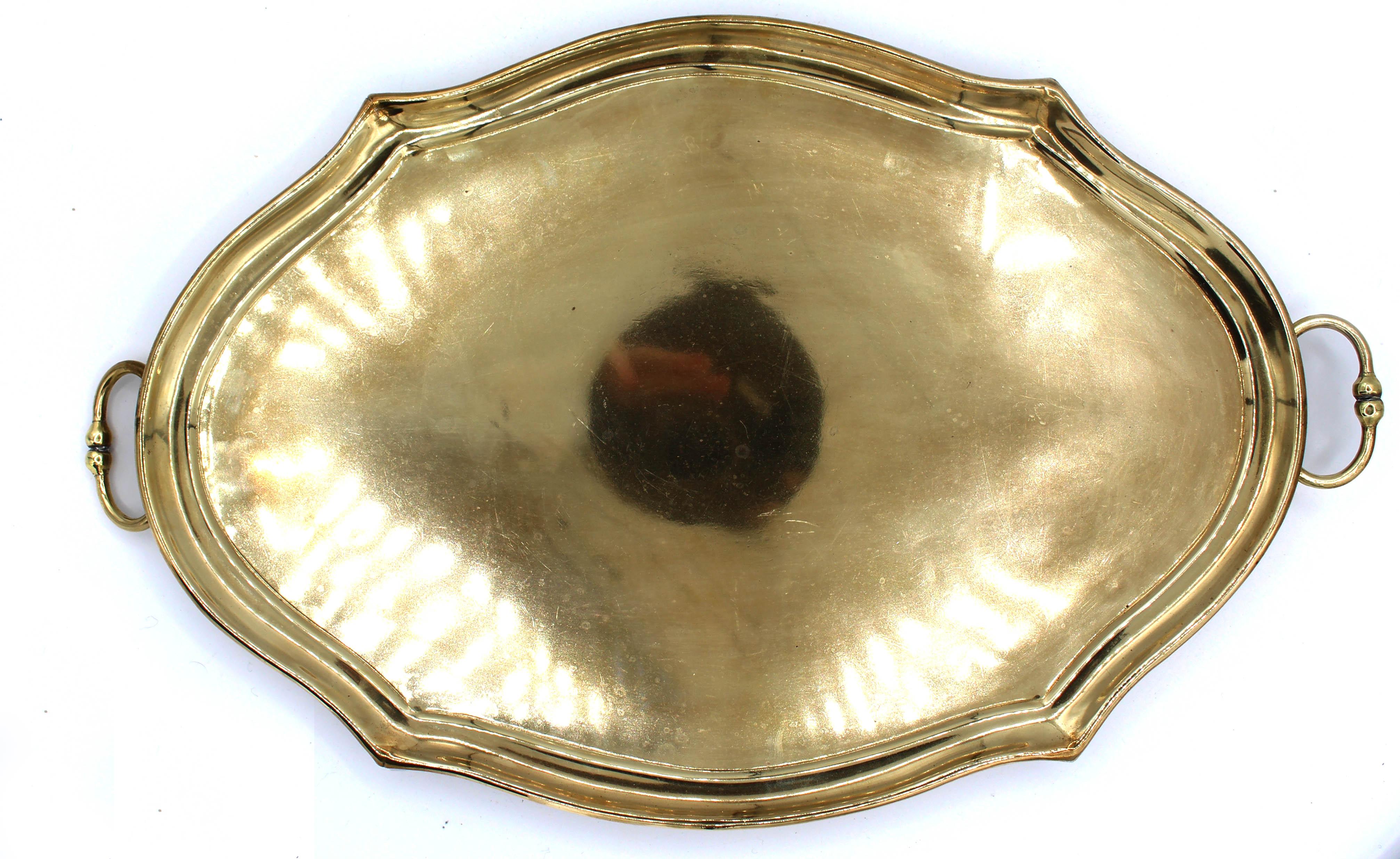Mid-20th century cartouche form brass cocktail tray, English. Handsome, in traditional Chippendale style. Scrolled tip feet. Swing handles.
16