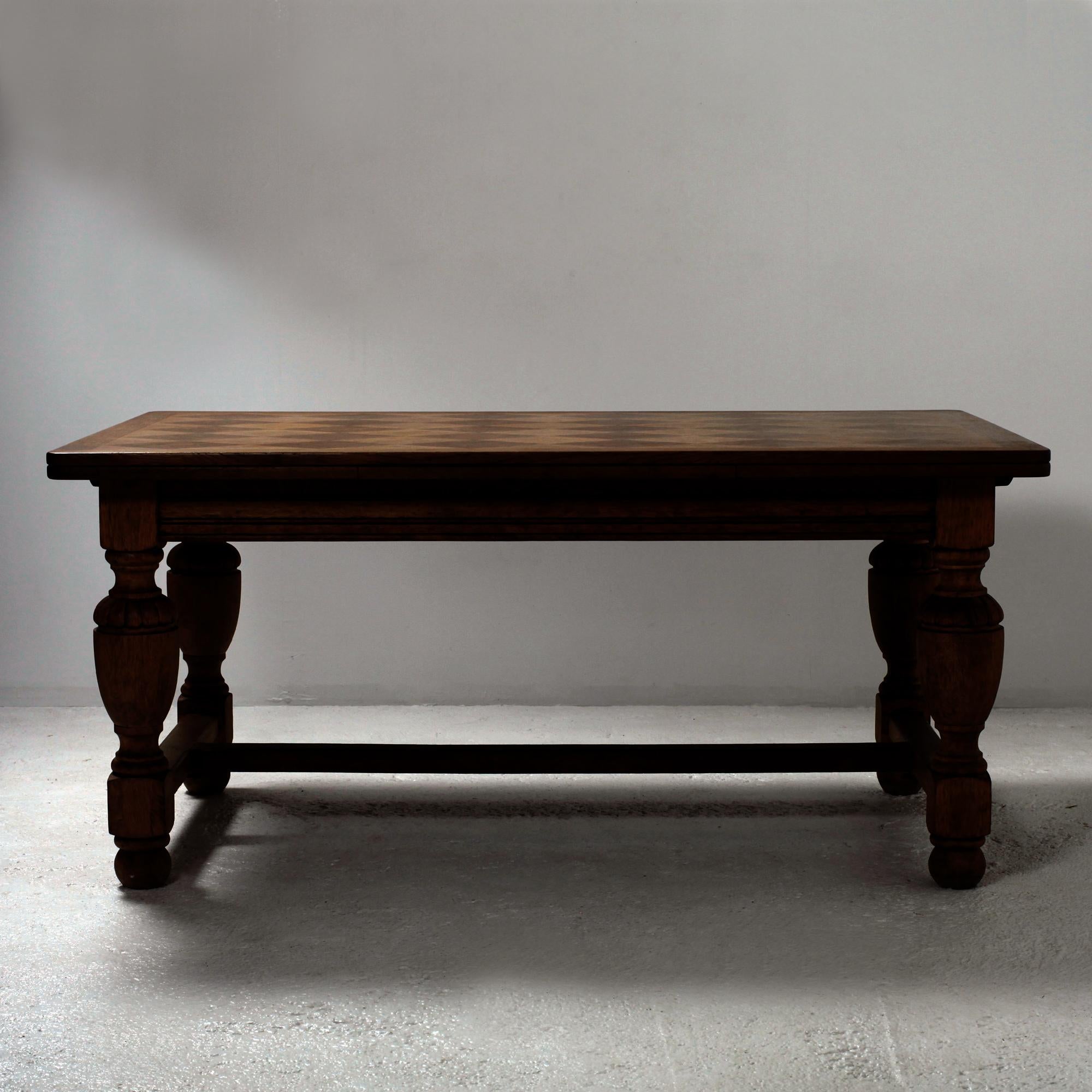 Mid 20th century country french provincial oak dining table in the style of Jean-Charles Moreux. Circa 1940
The table features beautifull marquetered oak top supported by a trestle base.
The trestle is constructed with thick, chunky turned and