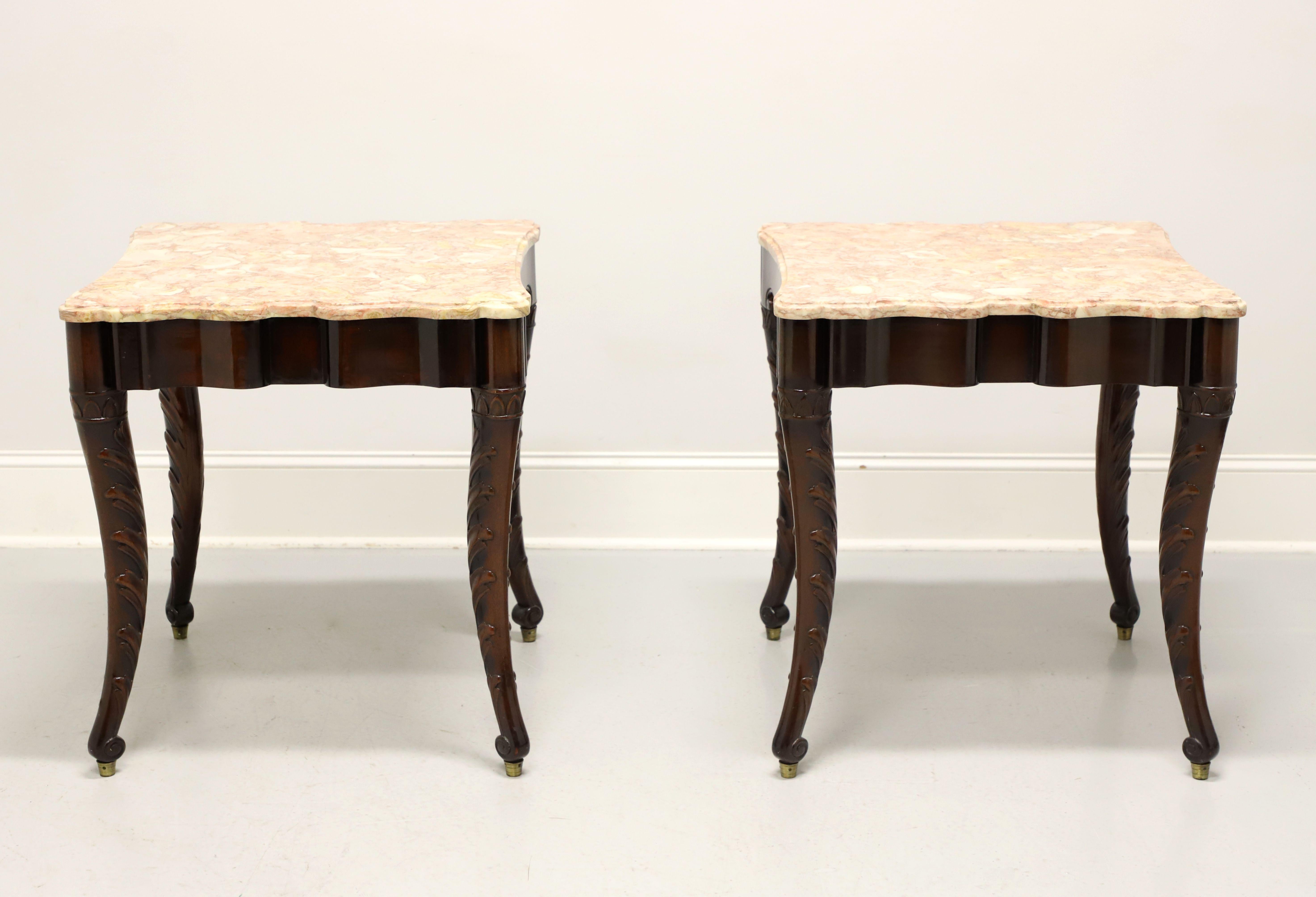 A pair of Regency style large side tables, unbranded. Solid mahogany with a serpentine shaped apron on two sides & carved apron to the other two, beveled edge pink & cream color marble top shaped to match the aprons, and acanthus leaves decoratively