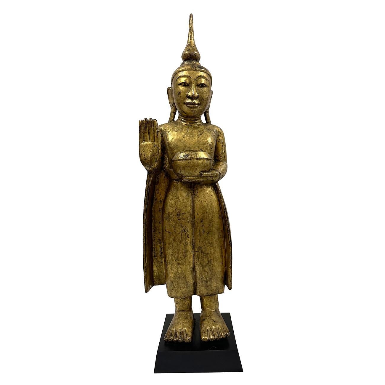 Set of 4 Thai hand carved wooden standing Buddha set on display stands. Beautifully carved and gilt in details. Dated Mid-20th Century. Great addition to any collection or eye-catching accent pieces.

Size: 32in H x 8.5in W x 7in D
25in H x 6.5in W