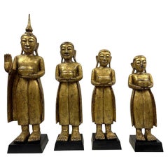 Mid-20th Century Carved Wooden Gilt Standing Thai Buddha Statues, Set of 4 Mid-20th Century Carved Wooden Gilt Standing Thai Buddha Statues, Set of 4