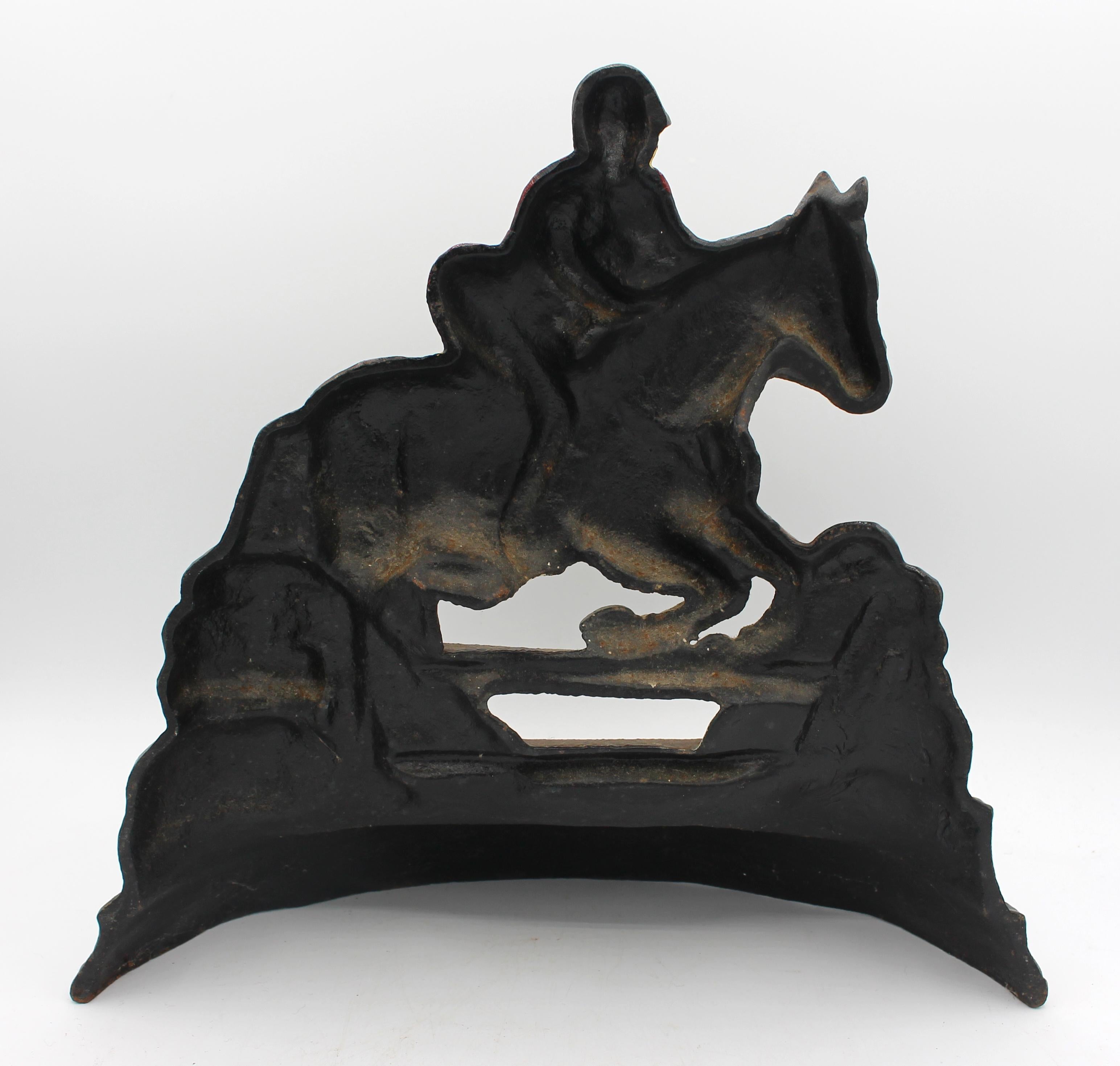 Mid-20th century cast iron horse & rider doorstop, English. Painted & gilded - refreshed over the years. Well modelled & cast. The rider in traditional fox hunting outfit jumping a rail. 13.5