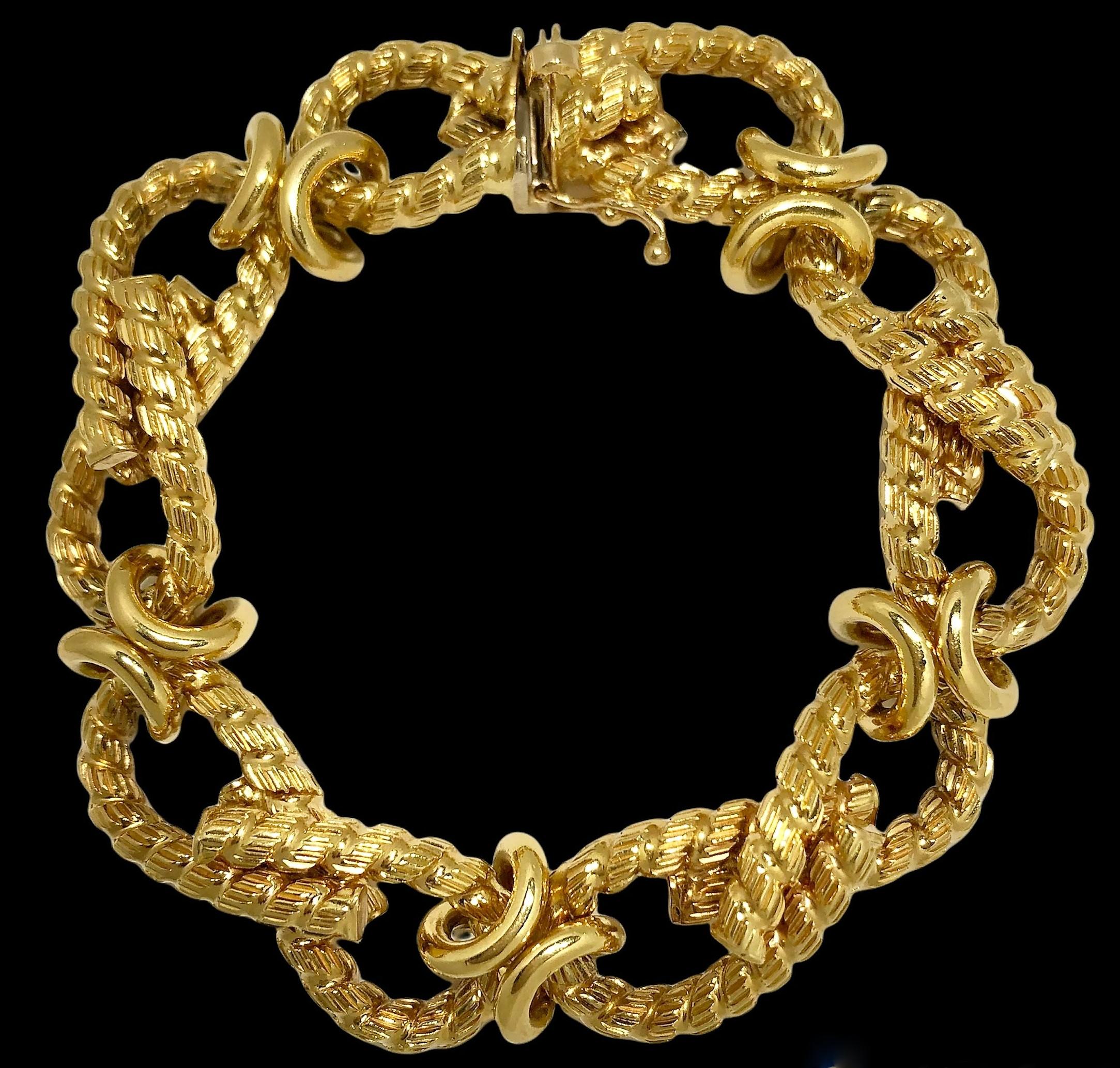 This lovely mid-20th century 18k yellow gold every day bracelet is comprised of  four twisted rope, textured figure eight eternity links all connected by high polish cinches. Measurements are a full seven inches in length and over 1/2 inch in width.