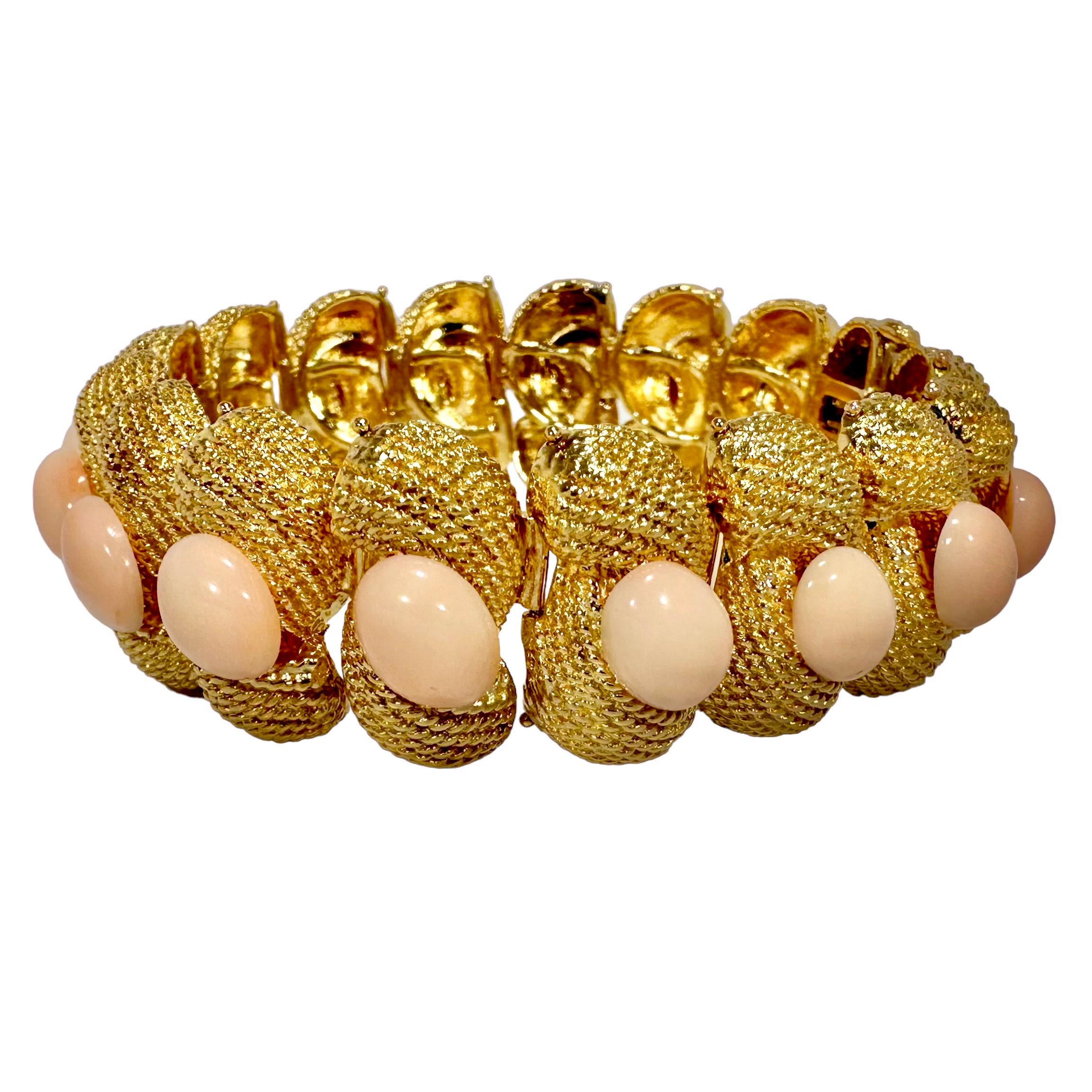 This lovely 18k yellow gold and Angel Skin coral cocktail bracelet is big and bold, capturing the optimism and positivity of mid-century America and the world at large. Deftly crafted and textured links depicting twisted rope swaddle a total of