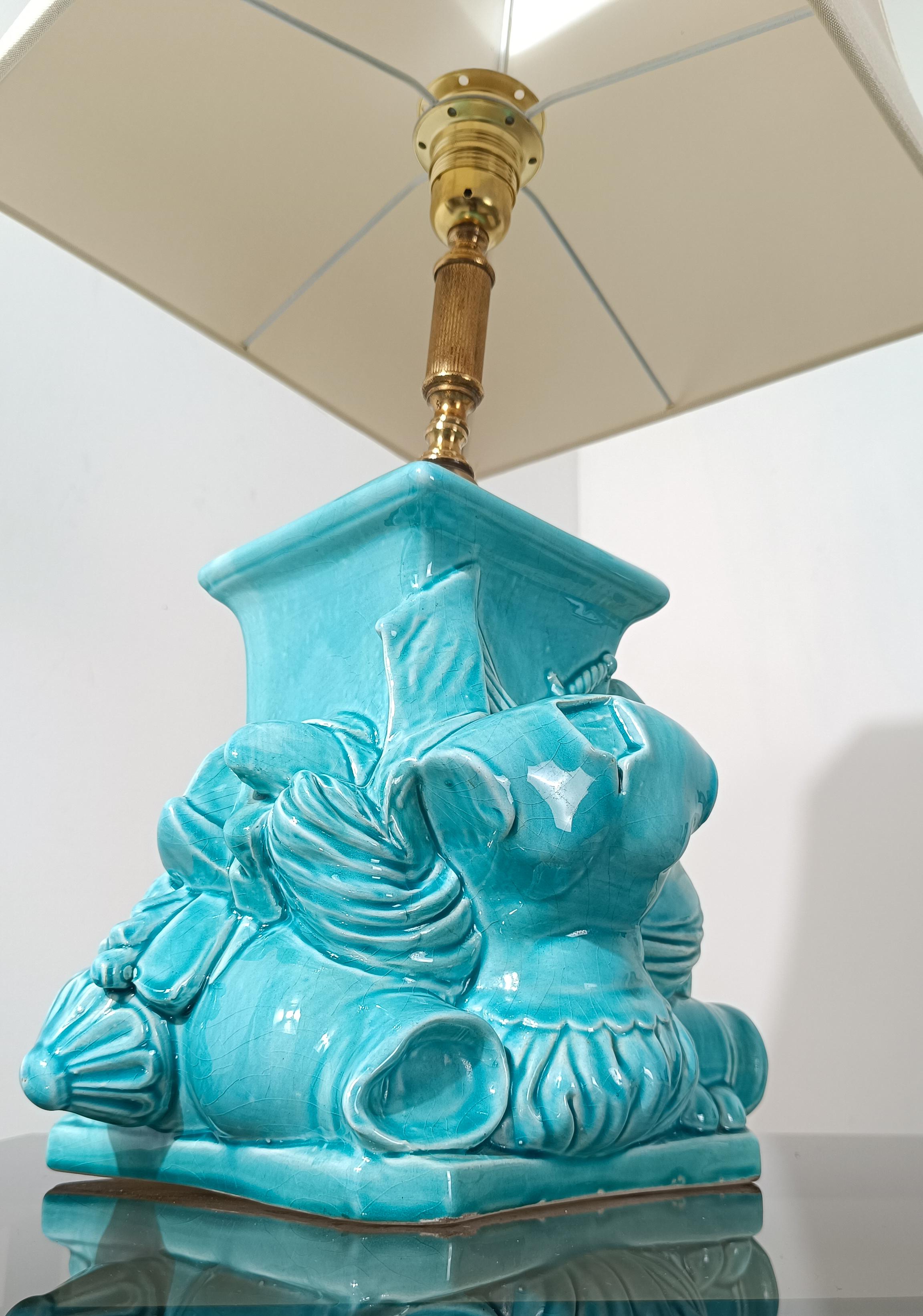 I offer for sale a splendid lamp handcrafted in Italy around the mid-20th century modern and which recalls in its composition of decorative elements that make up the turquoise ceramic base, the Italian Renaissance.
As Piero Fornasetti did in his