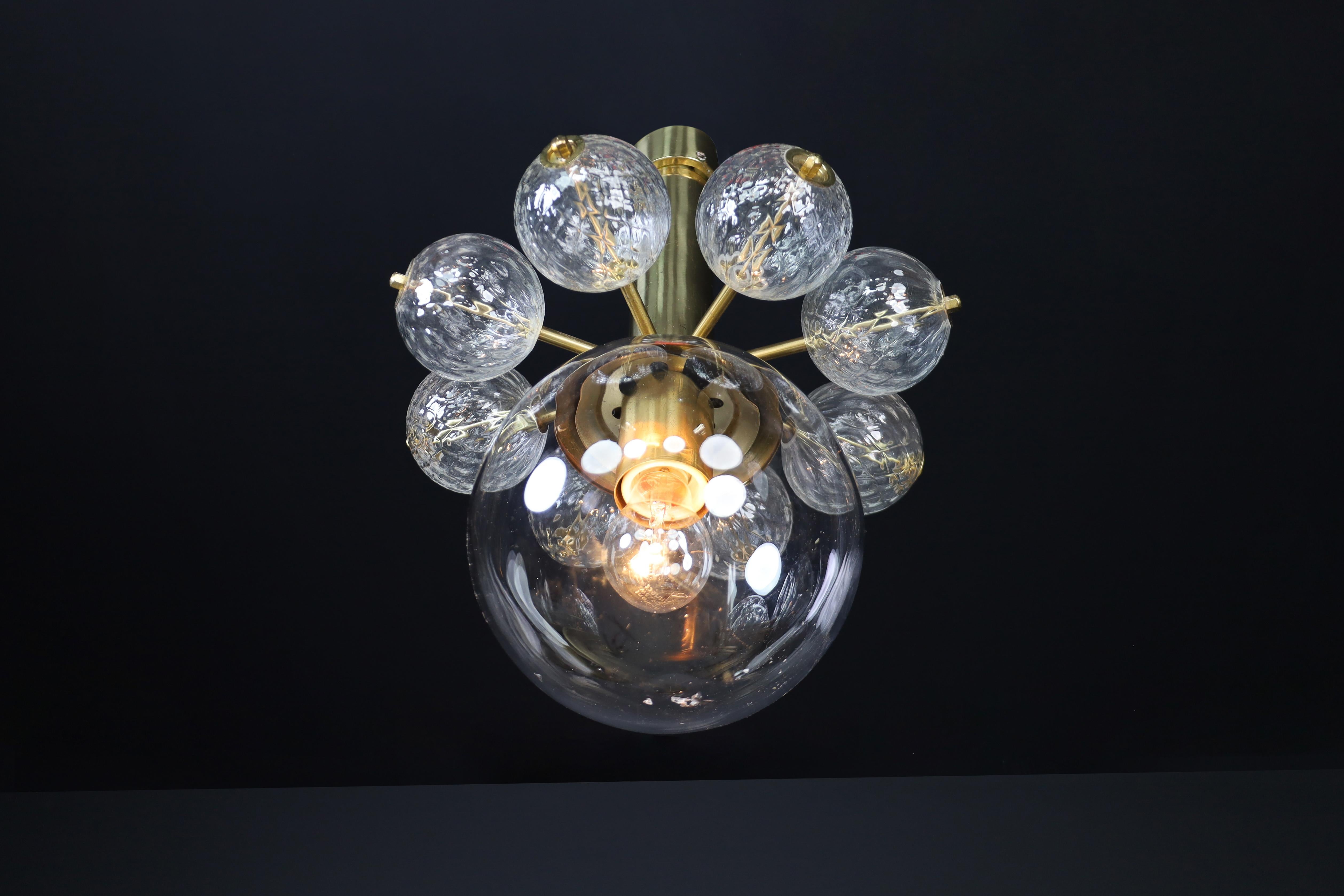 Mid-20th Century Chandelier with Brass Fixture and Hand-Blown Glass Globes

An exquisite example of Mid-Century Modern elegance, this chandelier combines refined materials with sculptural form, reflecting the exceptional craftsmanship of Bohemian