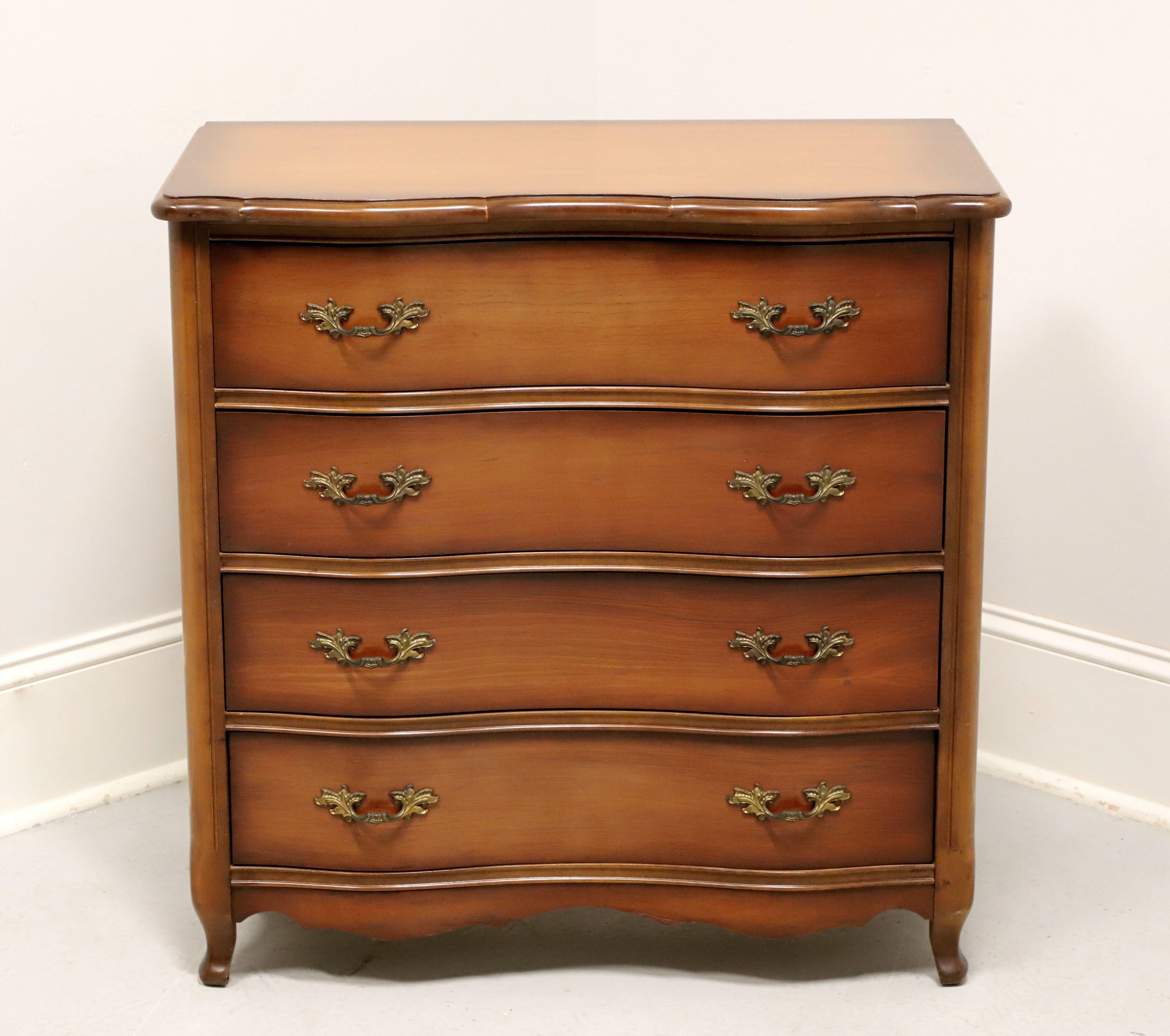 A French Provincial style bachelor chest, unbranded. Cherry wood with brass hardware, ogee edge to top, serpentine front, carved apron, and scroll front feet. Features four drawers of dovetail construction. Made in the USA, in the mid 20th century.