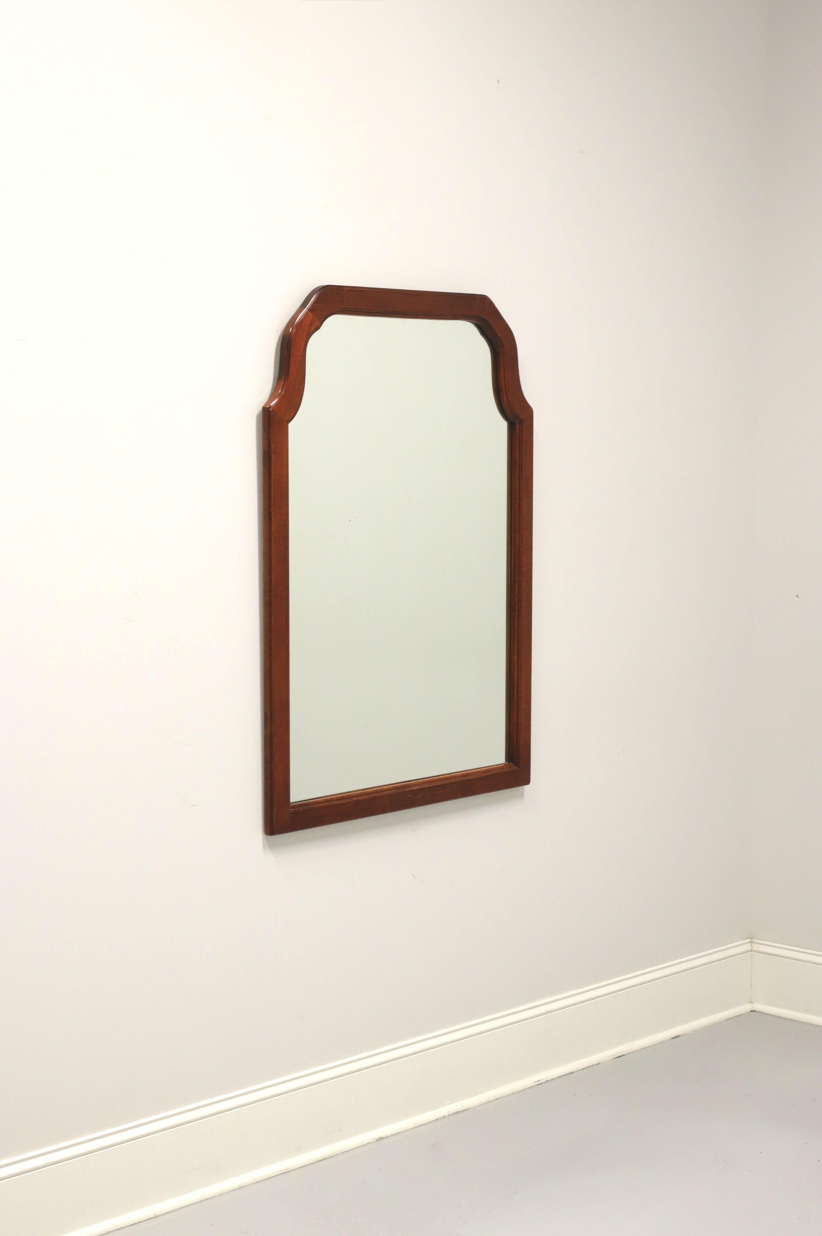 A Traditional style wall mirror, unbranded, similar quality to Craftique or Henredon. Mirrored glass in a cherry wood frame with flat arched top. Made in the USA, in the mid 20th century.

Measures: 31.5 W 1 D 43.5 H, Weighs approximately: 35