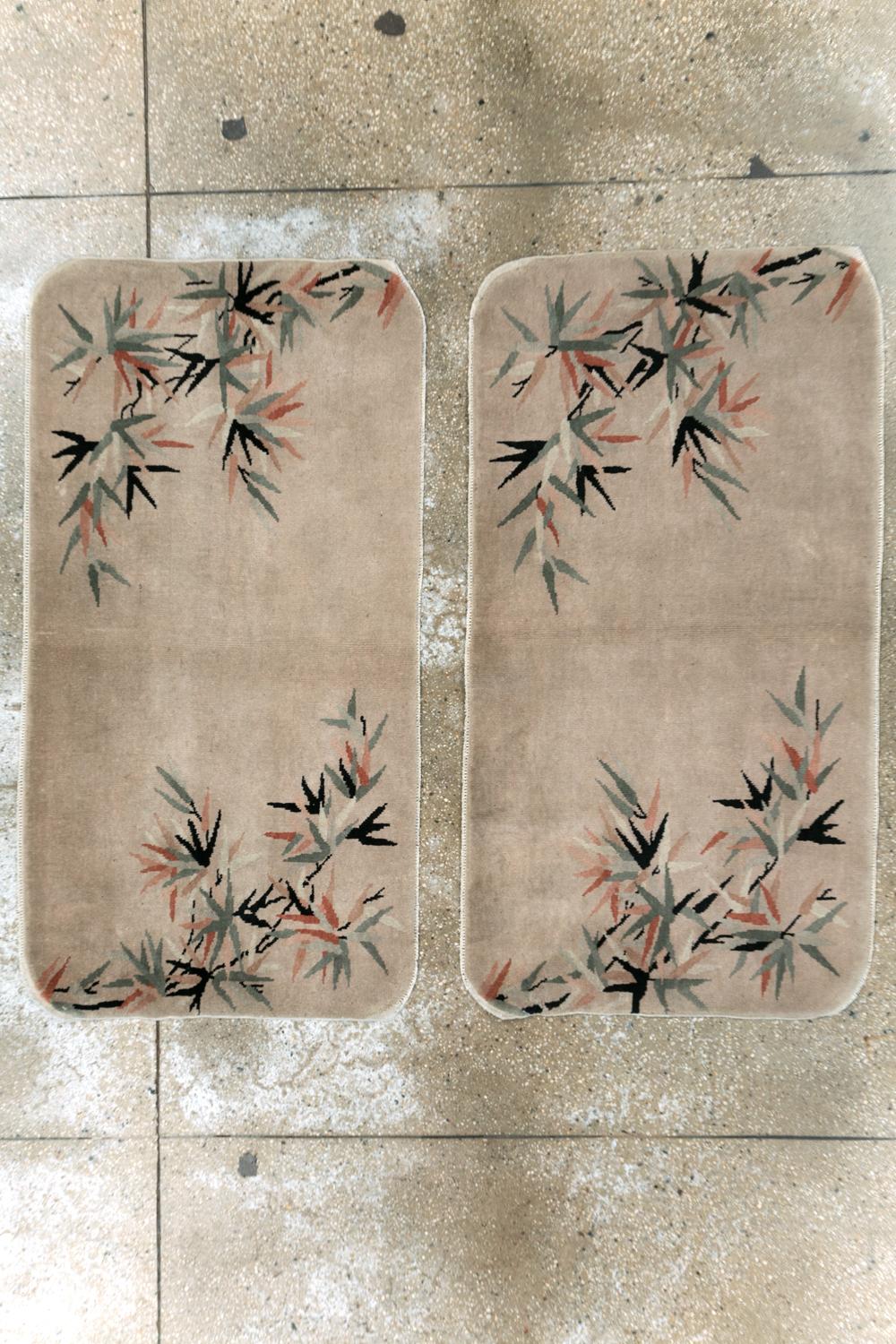 These mid-20th century Chinese Art Deco pair rug, measuring 2' 5
