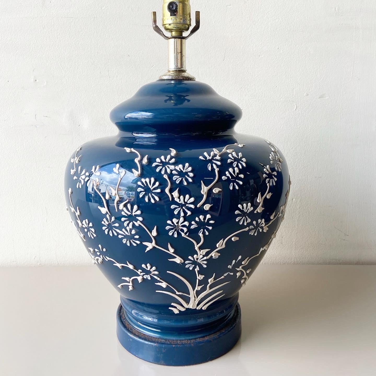 Navy Blue and white Chinese ginger jar lamp is delightful with white blossoms and branches painted on.
