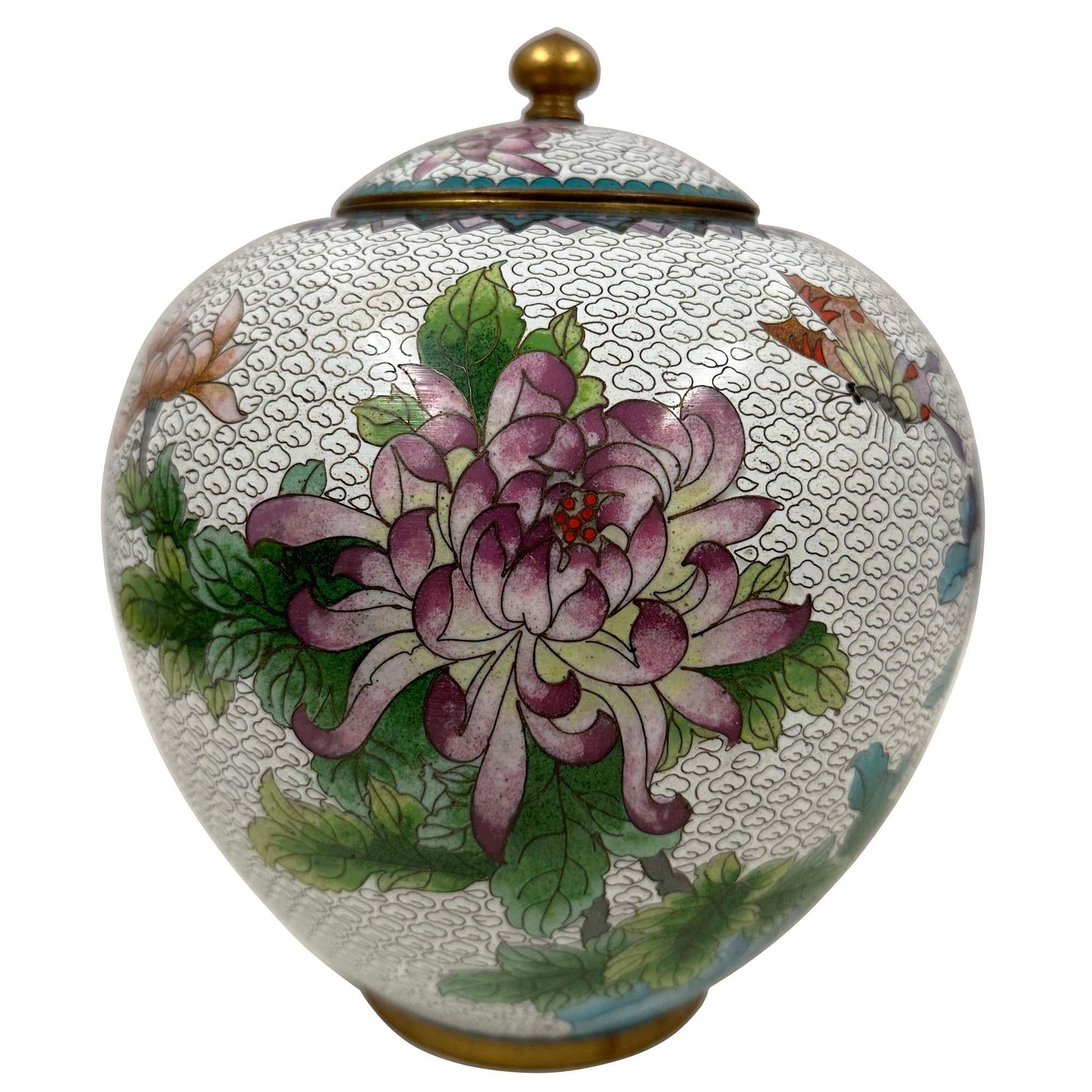 This is a cloisonné ginger jar, a type of decorative enamelware. Cloisonné is an ancient technique for decorating metal objects, where thin metal wires are soldered to a metal surface to create compartments, or 