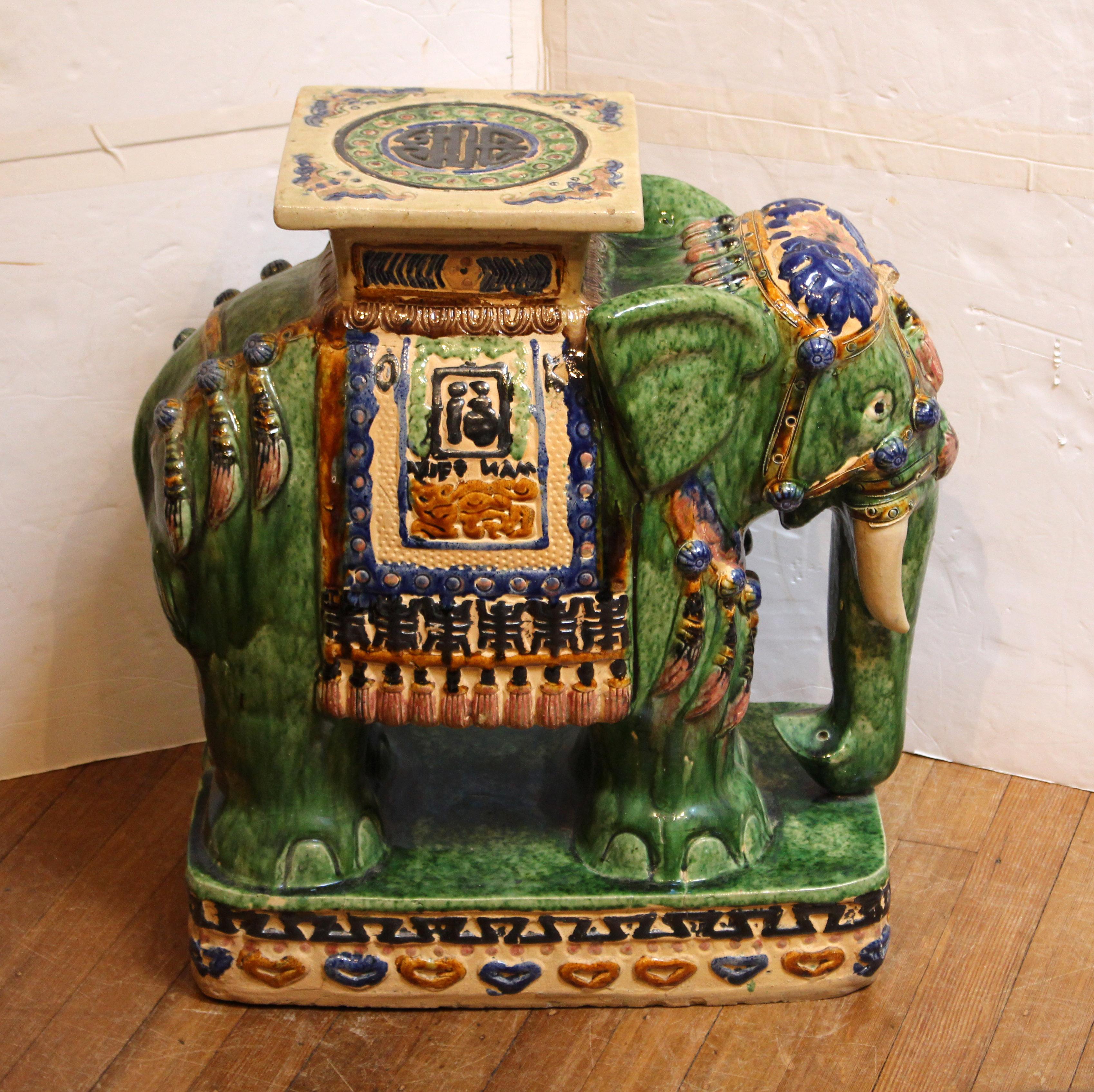 Mid-20th century Chinese elephant form large garden seat or side table. Terracotta & polychrome glazed. Colorful hand painting enhances the symbols of long life & happiness as well as the charm of his trappings. Minor rubs & bottom nicks
