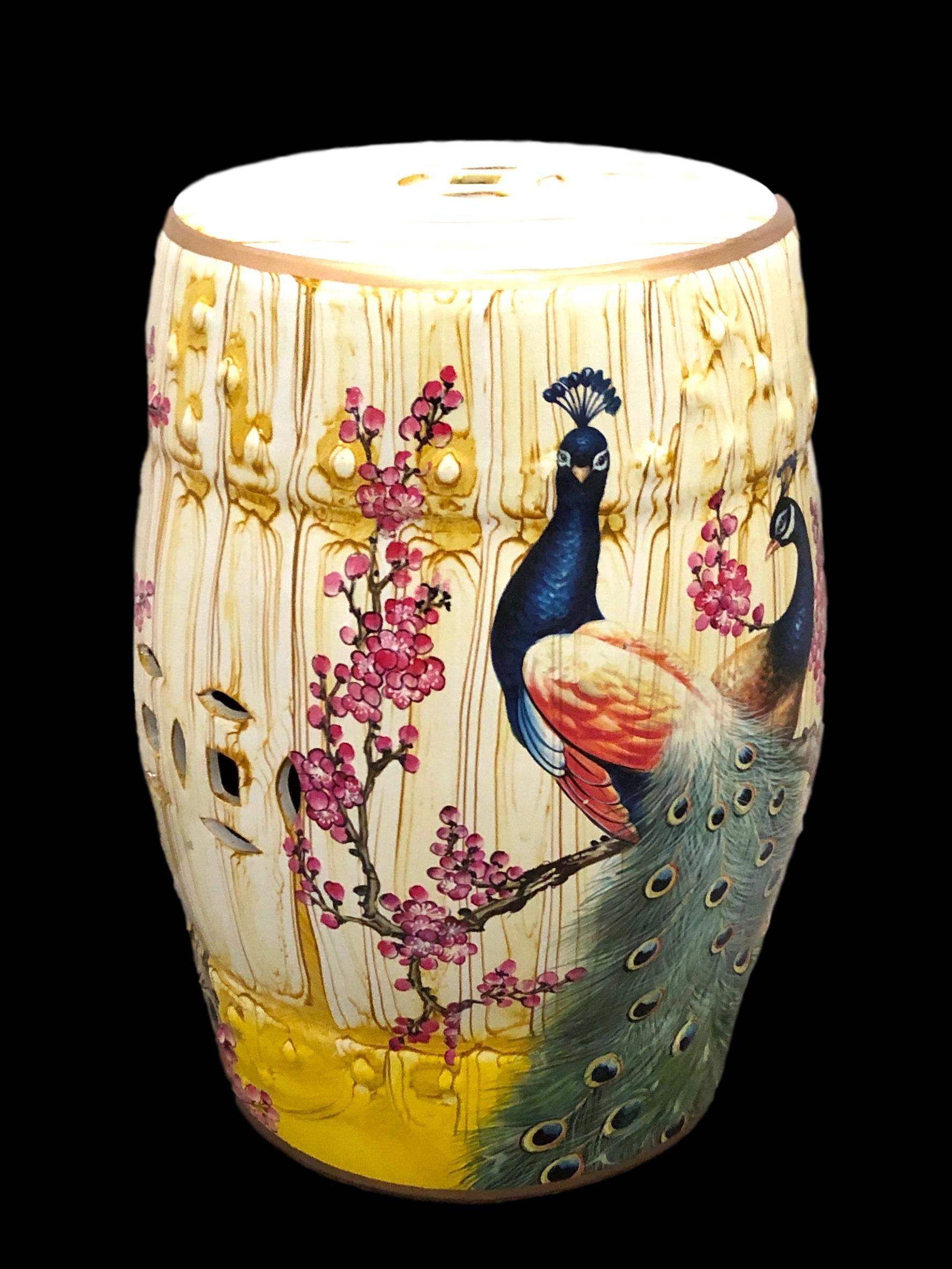 Mid-20th century Chinese export hand painted porcelain yellow and faux bamboo style garden stool or flower pot seat. This lovely piece has a flower and peacock motif on two sides. Features raised dot detail and Chinese geometric cut-out symbols on