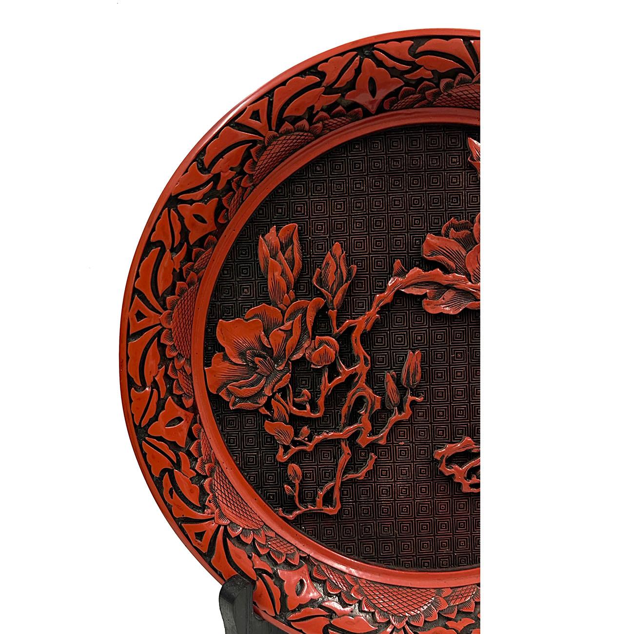 This stunning Chinese hand carved cinnabar lacquered plate has Intricate lacquer carving arts of Chinese traditional Floral scene design, an original works of art in the tradition of Chinese folks. It shows Intricate lacquer carving arts of a