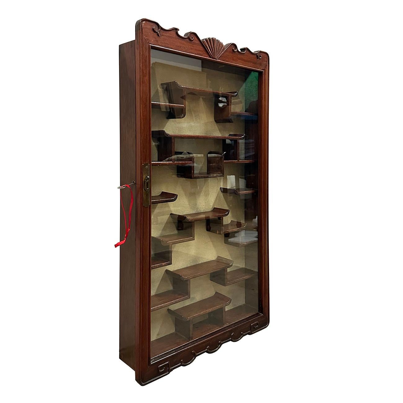 This Vintage Chinese Wall Mounted Curio cabinet is hand made and hand carved with one single glass door on the front. It is perfect for all your Treasures & Miniatures. It has 23 shelves for display your treasures. Mounted on a wall, solid hardwood