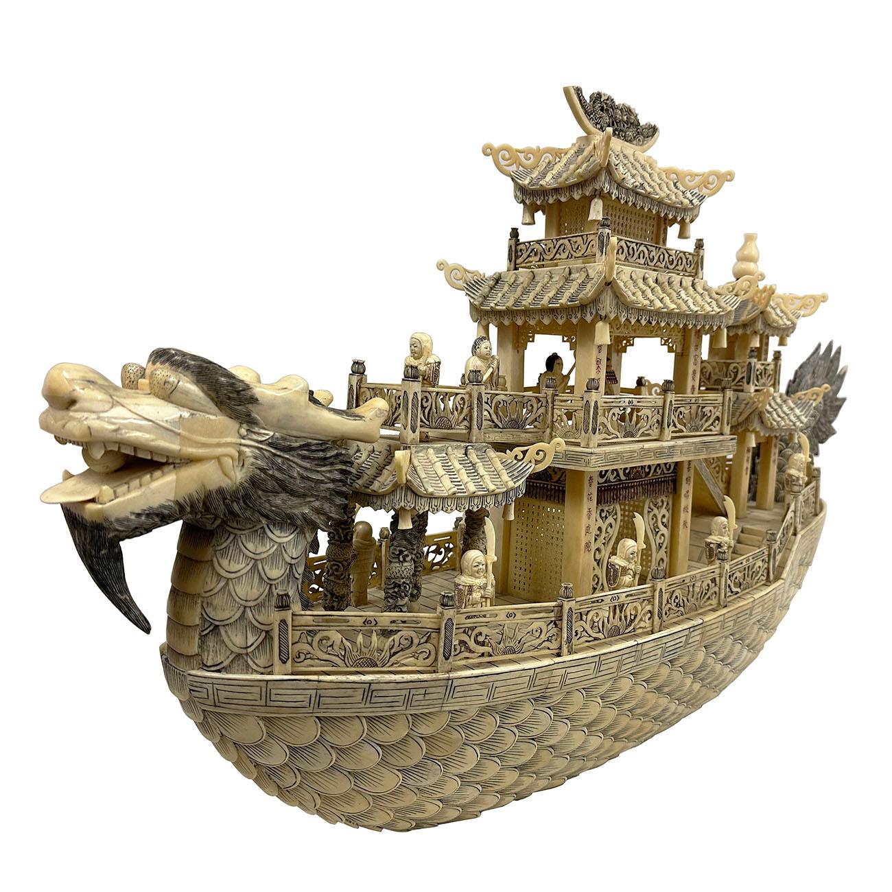This large imperial dragon boat was intricately and elaborately carved with brilliant lattice work and details. The emperor is seated with attendants and guards - 13 figures total. All figures are elaborately carved. The pagoda form structures are
