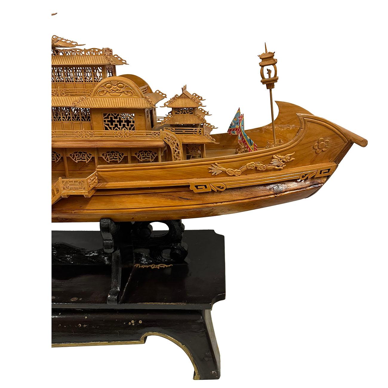 This large model of imperial dragon ship was intricately and elaborately carved with brilliant lattice work and details on the display stand. It actual a royal palace built on the ship. The entire ship were extremely fine carved to scale according