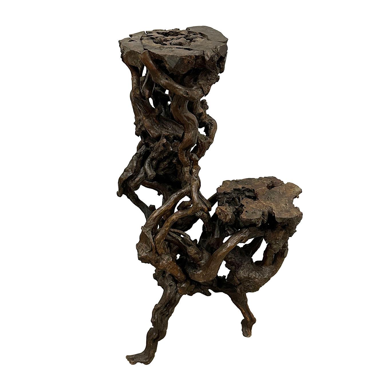 A vintage Chinese sculptural pedestal from the Mid-20th Century, made from the tree root with natural finish. Created in China during the Mid-century period, this pedestal attracts our immediate attention with its intricate lines and unique design -