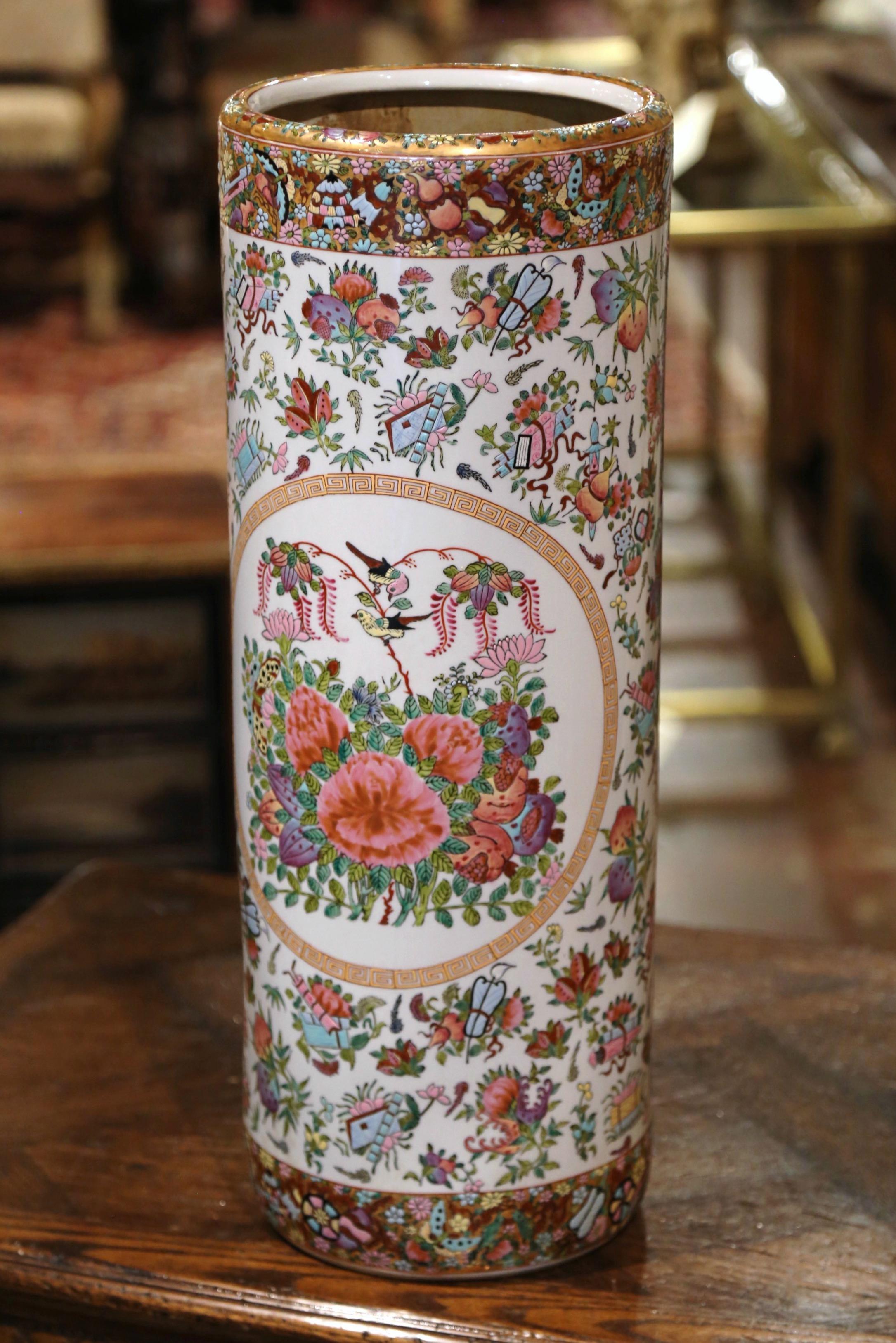 Created in China circa 1950, this large colorful rose medallion stand is round in shape and features hand painted floral reserves with birds and foliate motifs on a white background. The porcelain cane or umbrella stand is in excellent condition