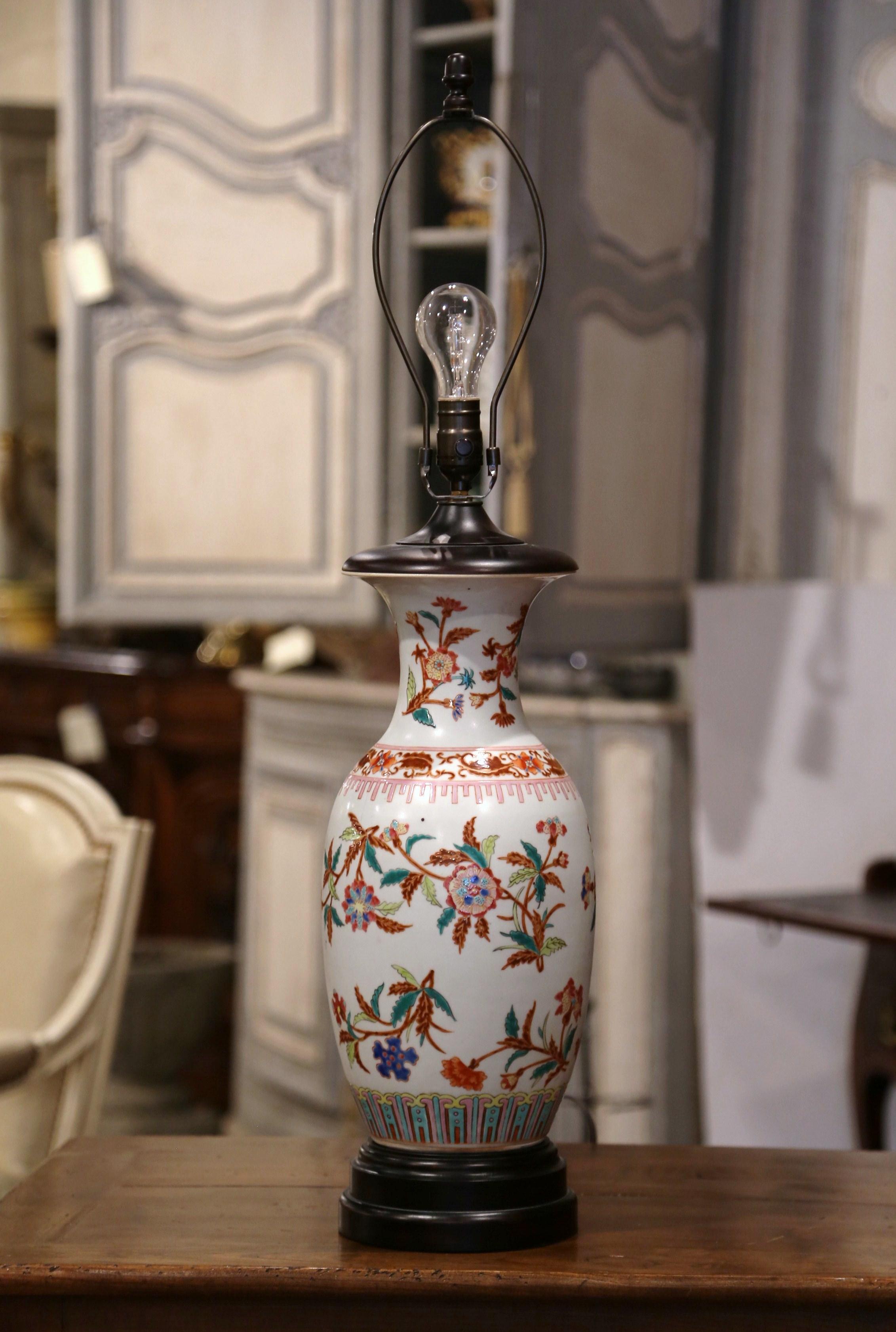 Add the perfect amount of chinoiserie into your home with this decorative porcelain lamp. Round in shape, the lamp was made by converting a vintage Chinese Famille Rose vase into a Classic table lamp. The ceramic vase is hand painted with floral