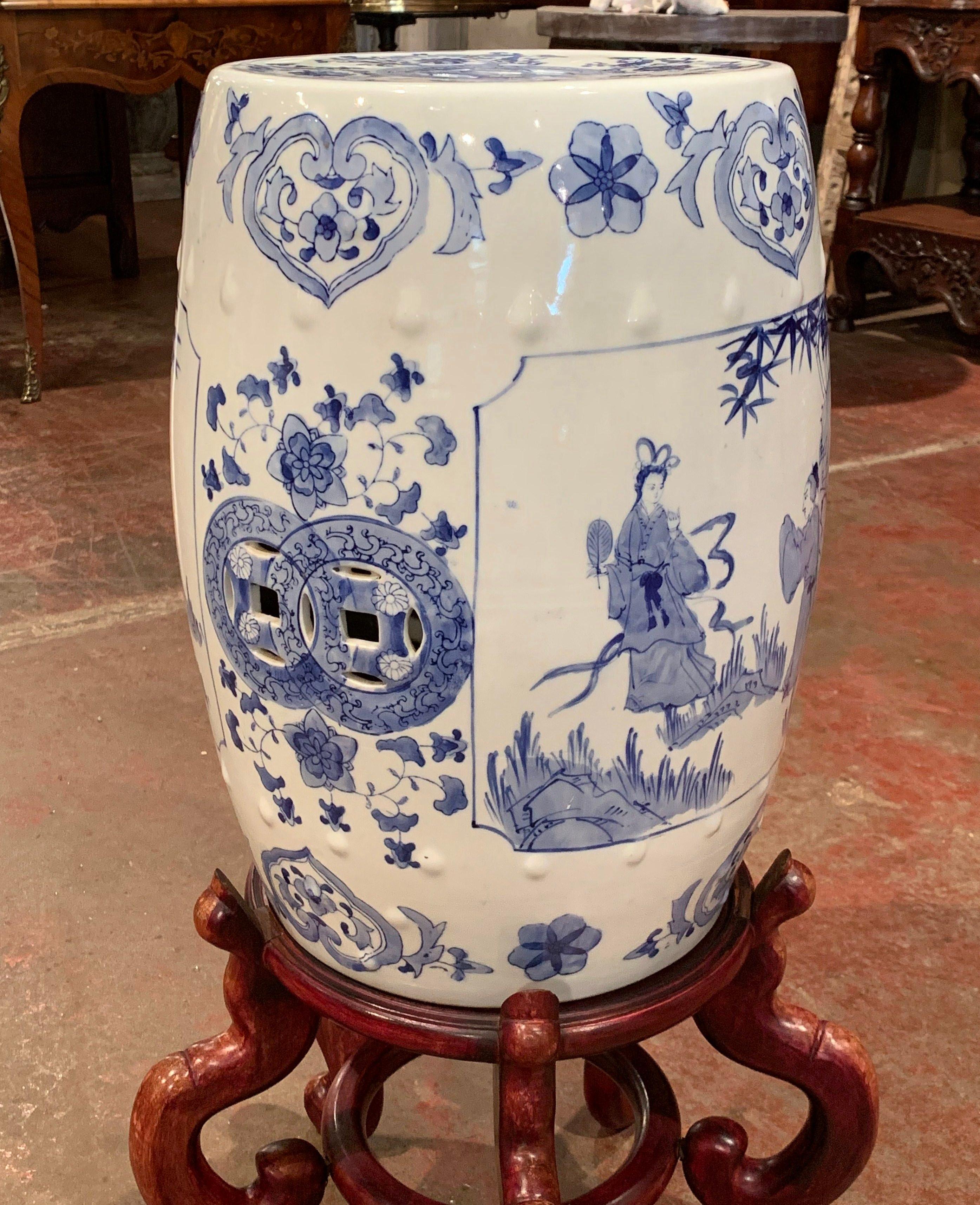 Use this colorful stool as extra seating in a den or game room or keep it on stand and use it as a side table. Crafted in China, circa 1960, the decorative porcelain stool is round in shape; it sits on a carved stand, and features cut out or pierced