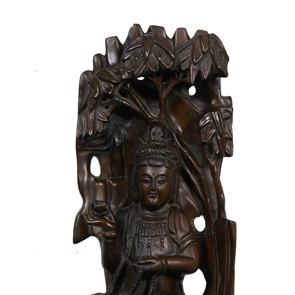 This magnificent vintage Chinese Wood Carved Kwan Yin Statuary has intricate carving works. It is all hand made and hand carved Kwan Yin sitting under the tree and holding a flower in her hand from boxwood. Very detailed.  You can see from the